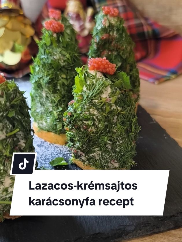 Füstölt lazacos-kapros karácsonyfák
 Hozzávalók kb. 6 fácskához:
 ● 1 doboz natúr krémsajt,
 ● 1 doboz ricotta,
 ● 80 g füstölt lazac,
 ● 15 dkg reszelt félkemény sajt,
 ● 1 közepes fej lila hagyma,
 ● 1 kk. só,
 ● 1 kk. frissen őrölt bors,
 ● 4 csomag friss kapor,
 ● 1 csomag friss petrezselyem,
 ● kiflikarikák vagy sós kréker „talpnak”
 ● 1 doboz nyúlhal-ikra.
 Elkészítés:
 A lazacot és a lila hagymát vágjuk apróra, és tegyük egy tálba, adjuk hozzá a krémsajtot, a ricottát és a reszelt sajtot. Sózzuk, borsozzuk, és keverjük össze, hogy egy kézzel jól formázható masszát kapjunk. Ha nem elég sűrű, reszelt sajt hozzáadásával javíthatunk az 
 állagán. A kiflikarikákat pirítsuk meg serpenyőben, sütőben vagy air fryerben. A petrezselymet és a kaprot aprítsuk fel, és terítsük szét egy deszkán vagy lapostányéron. 
 Az ikrát is terítsük el mellette vékonyan, kb. fél tenyérnyi területen. Formázzunk a lazacos-sajtos masszából kúpokat, amelyeknek az alja nem nagyobb, mint egy kiflikarika. Gyorsan forgassuk meg először az ikrában, aztán a petrezselymes kaporban. Ezek után állítsuk őket egy-egy kiflikarikára. A csúcsára tegyünk egy kis ikrát „csúcsdísznek”. #recept #mutimiteszel #cooking #EasyRecipe #nekedbe #tiktokhungary #FoodTok #magyartiktok #fyp #sobors #soborshu #karácsony #karácsonyikészülődés #nekedbe #karácsonyirecept 