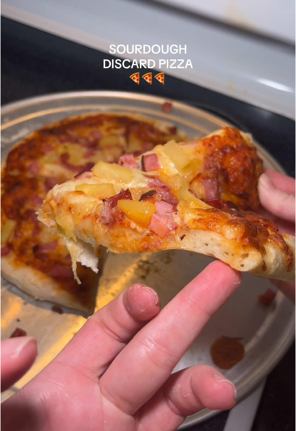 A win is a win 🍕🥇 - - DISCARD SOURDOUGH PIZZA * 4 ⅛ cups (500 grams) bread flour * 1 ¾ cups (400 grams) sourdough starter discard * 1 ¼ cups (300 grams) warm water 80-90°F * 1 ¾ teaspoons (10 grams) kosher salt Instructions * Mix Dough: In a large mixing bowl, combine the bread flour, warm water, sourdough starter discard, and kosher salt. Mix everything together until no dry flour remains and a cohesive dough forms. Cover the bowl and let the dough rest for 20 minutes. * Stretch & Folds: After 20 minutes, lightly wet your hands with water. Gently stretch one edge of the dough up and fold it over onto itself. Rotate the bowl 90 degrees and repeat, stretching and folding the dough a total of four times. After the fourth fold, flip the dough over so that the seam side is facing down. Cover the bowl again and let the dough rest for 15 minutes. Repeat the stretching and folding process for a total of 4-6 sets or until the dough appears smooth and feels elastic.  * Bulk Fermentation: Cover the dough and allow it to rise in a warm environment (70-75°F, 21-24°C) for about 2 hours. Note that it may take more or less time to rise depending on factors such as the warmth of your kitchen, the activity level of your sourdough starter, and the age of your discard. The dough should double in size and have noticeable gas bubbles forming on the surface. If your kitchen is cooler, consider placing the covered bowl inside an off oven with just the light on to provide gentle warmth.  * Divide & Shape: Carefully turn the dough out onto a lightly floured work surface. Using a bench scraper, divide the dough into 2 equal pieces. Shape each piece by gently pulling the dough into a rough rectangle. Then, fold the top edge of the rectangle down towards the center, pressing lightly to seal. Repeat this process with the bottom edge, folding it up towards the center and pressing lightly to seal. Next, fold the left and right sides of the rectangle towards the center, overlapping slightly, and press lightly to seal. Finally, flip the dough over so that the seam side is facing down, and use your hands to gently shape it into a smooth, round ball.  * Proof: Place the dough balls on a lightly floured surface or parchment paper and cover them with plastic wrap. Let them rest at room temperature for 15-20 minutes before using them for pizza.  * Stretch: After proofing, you can use the dough to make pizza immediately. Alternatively, transfer it to the refrigerator for up to 4 days for a more tangy flavor or freeze it for up to 3 months. To stretch the dough, take one of the proofed dough balls and place it on a lightly floured surface or a piece of parchment paper. Gently press down about an inch from the edge dough with your fingertips to create a crust, working your way around the dough, to start stretching it into a round shape. Continue to stretch the dough by gently pressing and pulling the edges outward, rotating the dough as needed, until you've reached your desired size and thickness for the pizza crust. If the dough starts to resist stretching or springs back, let it rest for a few minutes and then continue stretching.  * Preheat oven to 500°F. Build pizza on the sheet pan, then transfer the baking sheet to the preheated oven. Bake pizza for 15 minutes. #sourdough #sourdoughstarter #sourdoughdiscard #discardpizza #sourdoughpizza #sourdoughtok #sourdoughforbeginners 