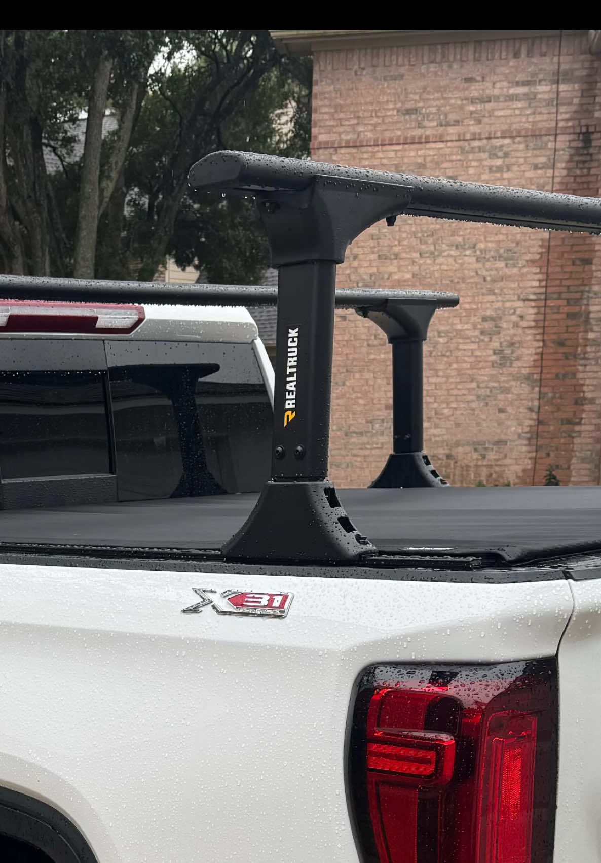 I’ve partnered with my friends @RealTruck to install their BRAND NEW Truxedo Pro X15 TS Soft Roll-Up Tonneau Cover w/ T-Slot Rails! The great thing about this tonneau in particular is the built-in T-Slots, which allows you to use bed racks and other accessories while having the protection and security of a tonneau cover! RealTruck’s all-new TruXedo Pro X15 TS is the sleekest looking soft roll-up truck bed cover with easy rack compatibility built-in, offering effective cargo protection with an added capability uncommon in typical bed covers. The new Pro X15 TS features an extra-low profile thanks to its specially designed 15-degree side rails. When closed, the cover sits flush with the bed rails, creating a clean, stealthy appearance as it nearly disappears into your pickup’s bed. Powder-coated aluminum side rails and support bows provide strength to support the Pro X15 TS’s durable woven canvas, while automatic tension control keeps the cover taut and sag-free regardless of outdoor temps. With all your cargo safe and dry, Pro X15 TS raises its game by implementing versatile T-slot channels into the rails, allowing you to effortlessly expand your bed’s cargo-carrying abilities.  Adding crossbars, cargo racks, bike carriers, storage boxes, and accessory mounts above the bed opens your truck to a world of possibilities. - - - #realtruckpartner #bringyourtrucktolife #realtruck #realtrucknation #truckproducts #aftermarket #automotive 