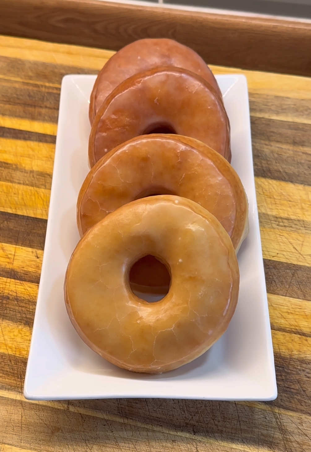 Easiest Glazed Doughnut Recipe 😍 Dough Ingredients:  40g (3 tbsp) Unsalted Melted Butter  40g (3 tbsp) Granulated Sugar  Half tsp Salt  1 Large Egg 125ml (half cup) Full Fat Milk (room temp) 1 tsp Instant Yeast  280g (2 cups) Bread Flour + Extra for Surface  Glaze  75g (5 tbsp) Unsalted Melted Butter  3 Tbsp Full Fat Milk (Luke warm) 1 tsp Vanilla Extract  250g (2 cups) Icing Sugar #donuts #baking #EasyRecipe #food #howto 