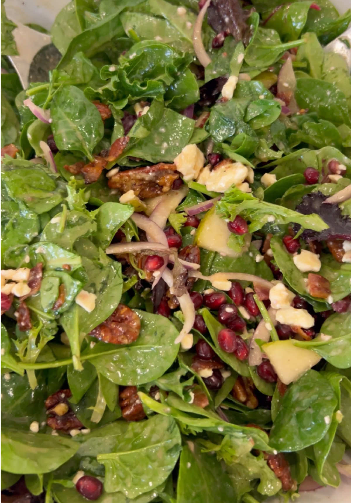 Had to share this recipe again because I left an ingredient off when typing up the recipe the first time!😩  the salad is a must make!! POMEGRANATE PEAR & PECAN SALAD WITH LEMON VINAIGRETTE DRESSING INGREDIENTS: * 5 cups baby Spinach * 5 oz package baby spring mix (4 1/2 cups) * 1 scant cup Feta cheese crumbles * 1 cup Pomegranate seeds (or to taste) * 6-7 slices bacon, diced * 1 pear, sliced * 1 cup pecan halves (as many as desired) * 1/4 cup white sugar for pecan halves  * 1/2 small red onion, thin sliced DRESSING: * 3/4 cup olive oil * 1/4 cup white balsamic vinegar  * 1 lemon, zested (1 Tbsp lemon zest)and juiced * 2 tablespoons honey  * 2 tablespoons white sugar * 2 tablespoons Dijon mustard  * 3 sprigs fresh Thyme (remove leaves; about 1 teaspoon) * 1/2 teaspoon garlic powder  * 3/4 teaspoon kosher salt  * 1/2 teaspoon black pepper DIRECTIONS: 1️⃣Cut up bacon slices and cook over medium heat until crispy. Drain and set bacon aside.  In the same pan, add the pecan halves and sugar. Stir constantly until sugar melts, pecans are toasting, and sugar caramelizes. Pour out onto a piece of parchment paper and separate slightly so they don’t cool into one big clump.  2️⃣Thin slice the red onion. Zest the lemon. Remove pomegranate seeds or buy the prepared cups of Arils(pomegranate seeds). In a blender add olive oil, white balsamic vinegar, honey, 1 tablespoon of the lemon zest, sugar, salt, pepper, fresh, thyme, and garlic powder. Juice the lemon and add.  Blend until creamy smooth.   3️⃣In a large salad bowl add the baby spinach, baby spring mix, red onion, feta cheese, pomegranate seeds, candied pecans, and crispy bacon. Slice and add pear just before serving. ((Salad recipe can be halved if needing a smaller sized salad; this recipe makes a large sized one)) 4️⃣When ready to serve, drizzle salad with desired amount dressing. Can also be served up on individual plates and drizzled with dressing. Toss and Enjoy!!! #salad #saladrecipe #delicioussalad  #pomegranatesalad #greensalad #healthyrecipes #healthy #healthyliving #fyp #FoodTok #recipesoftiktok #tastyfood #bestrecipes #Recipe #feta #pecan #pomegranate #greens 