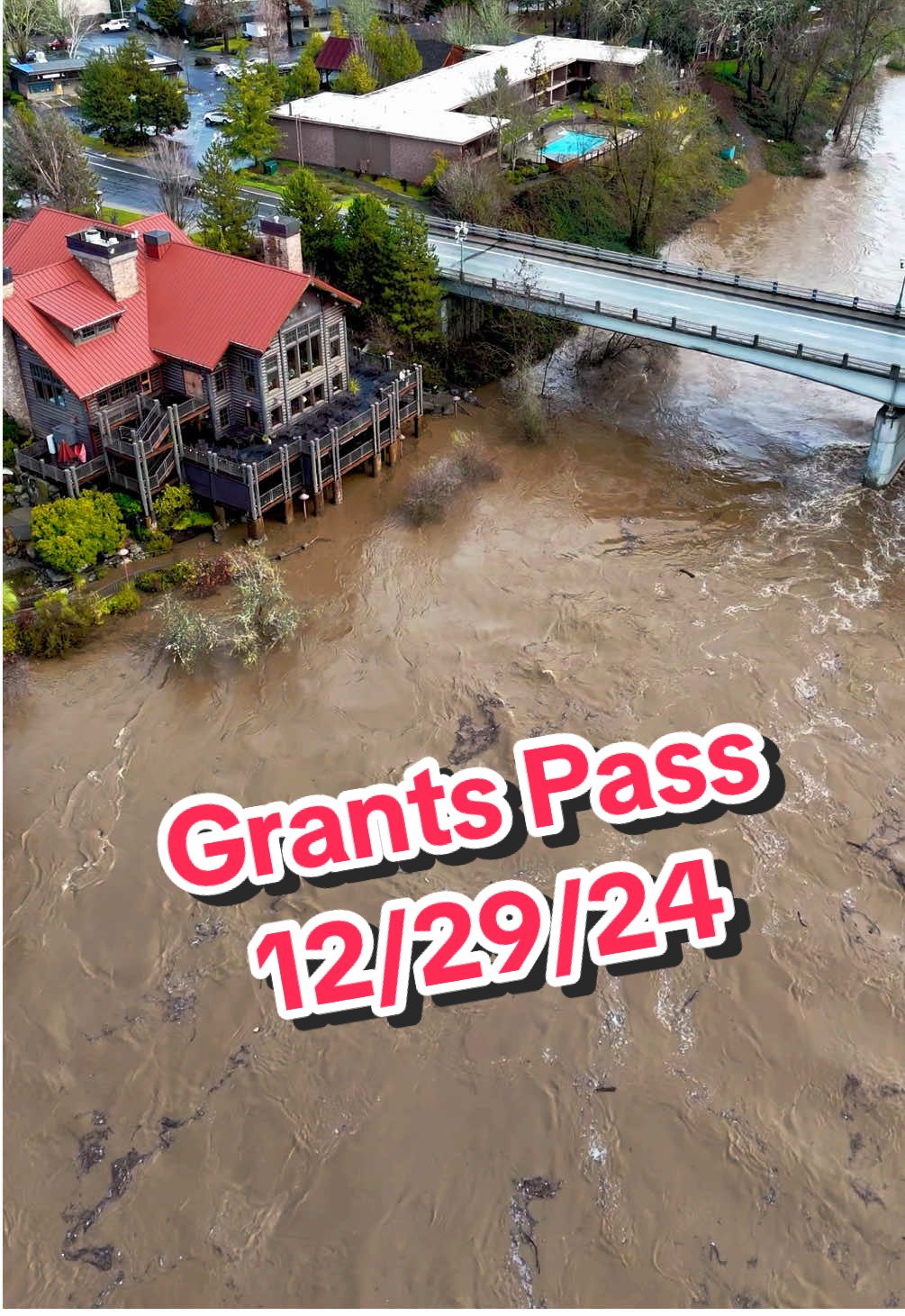 Grants Pass Rogue River 12/29/24 Water is rising (15ft) not quite flood stage but projected to possibly reach 18FT in a few hours 🤯 #oregon #grantspass #rogueriver #southernoregon #roguevalley #river #flood #rain #drone #storm #wow #tik_tok #gp #flooding2024 