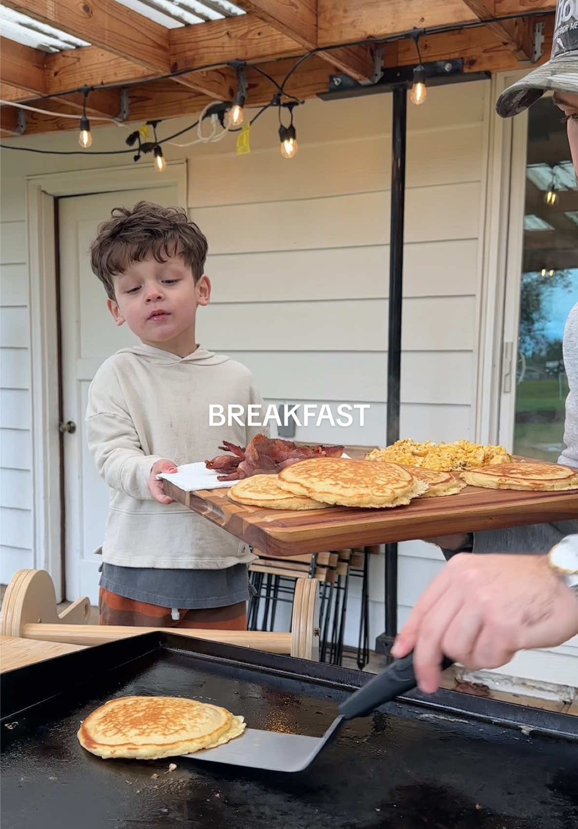 It’s nice having an extra pair of hands while cooking 😁 #blackstone #blackstonegriddlecooking #blackstonegriddle #blackstonedinner #cooking #dadlife #parenthood #marriage #cookwithme #Dinnerldeas #blackstonedinnerideas #food #family #husbandwife #eggs #blackstonebreakfast #pancakes #bacon #breakfastideas #breakfast #marriedlife 