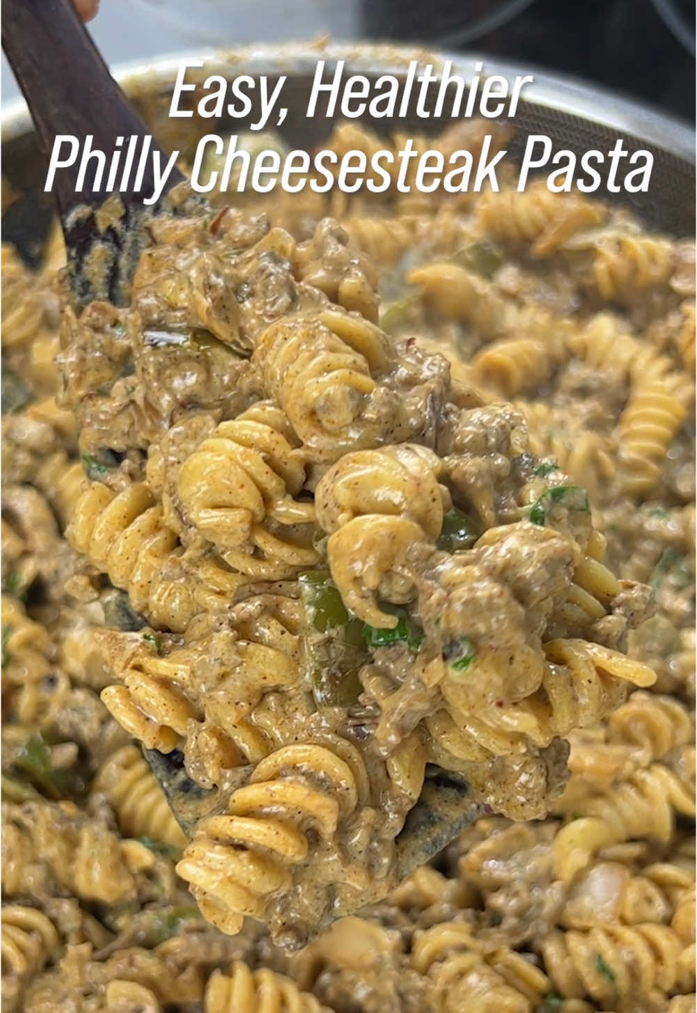 Philly Cheesesteak Pasta. PACKED with protein, lower in calories, creamy, cheesy and so delicious. Done in 20 minutes!👇🏼 - Pasta: • water (to boil) • salt • 1 & 1/4 cup pasta (any shape, approx 100g) - Beef Mix: • 1 tsp olive oil (or spray) • 1 small onion, chopped • 1 green bell pepper, chopped • 1 cup sliced mushrooms • 1 tbsp minced garlic • 1 cup lean ground beef or sirloin (the leaner it is, the lower the calories. I use 94% lean) • Season with 1 tsp salt, pepper, paprika and chili powder • 1/4 cup light cream cheese (I use 95% light) • 1/3 cup fat free greek yogurt, plain • 1/3 cup light mozzarella cheese • 1/2 cup pasta water - Toppings (optional): • Cilantro and Chili Flakes - Notes: • For some more traditional flavour, feel free to add provolone cheese, but in moderation due to calories! • When mixing the sauce, keep the heat low. • Use any type of pasta that fits into your calorie goals such as low-carb, chickpea, veggie, etc. • Double recipe and serve as a meal prep for the week! - Serving Size: • Approx. 2  - Calories/Macros (Per Serving): • Approx. 496 calories • 44.5g protein • 46g carbs • 15.5g fat - Numbers may slightly vary depending on the brands and ingredients you use. - - #Recipe #food #cooking #homecooking #healthy #protein #pasta #beef #phillycheesesteak #cheese #mealprep #healthyrecipes #healthyfood #healthylifestyle #dinner #lunch #fitnessjourney 