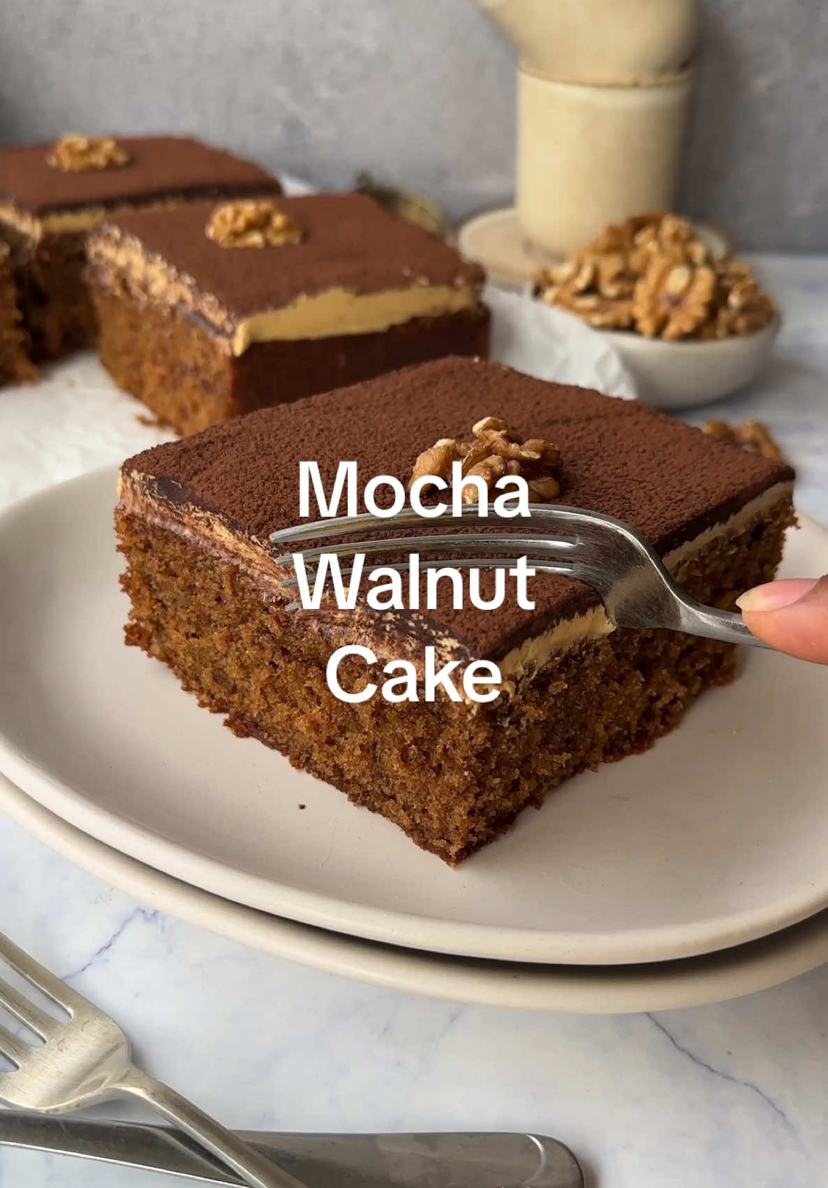 Mocha & Walnut Cake! Indulge in the luscious layers of our Mocha and Walnut Cake-where rich coffee meets crunchy walnuts for the ultimate treat! This moist sponge cake, infused with instant coffee and coffee essence, offers a delectable mocha experience that coffee lovers will adore. The addition of crushed walnuts adds a satisfying texture and nutty flavor, making each bite a true delight. Topped with a creamy coffee buttercream and finished with a dusting of cocoa powder, this cake is not only delicious but also beautifully presented. Perfect for any occasion, whether it's a cozy afternoon tea or a festive celebration, this cake is sure to impress! Treat yourself and your loved ones to a slice of bliss today! Full recipe on my website.