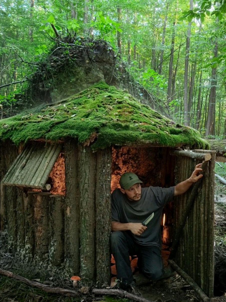 A cozy log cabin for survival  under an upturned root #survival #shelter #bushcraft #woodhouse #dugout #fyp #usa_tiktok 