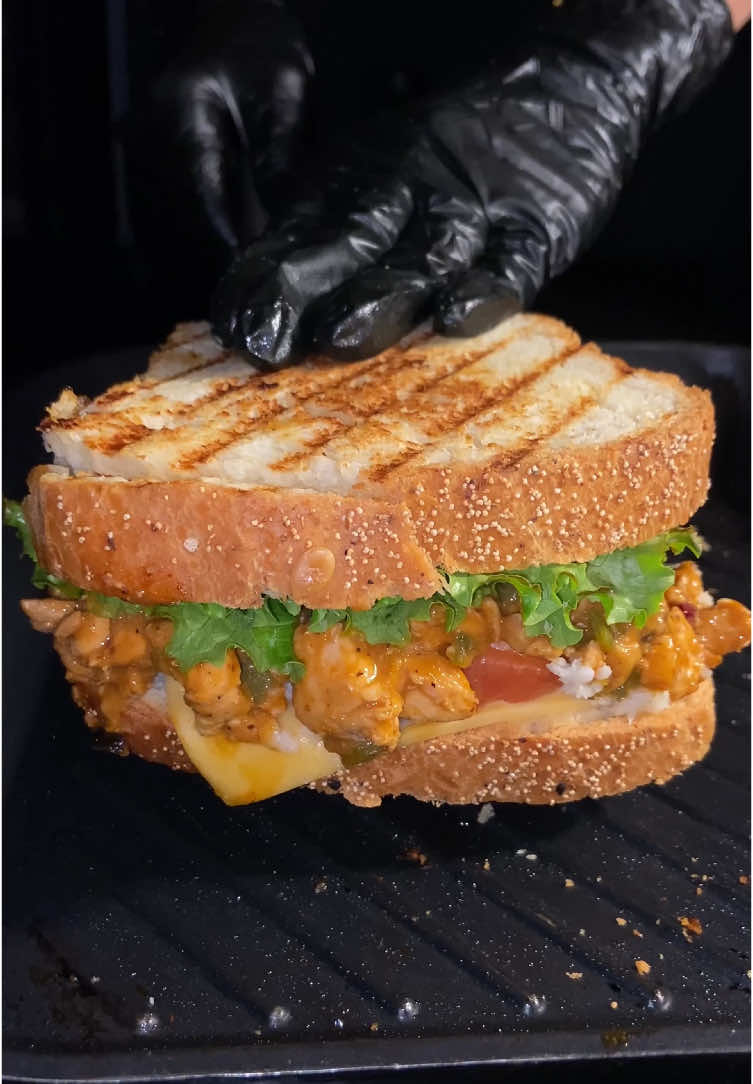 Loaded Chicken and Cheese Sandwich🥪  Try This Cheesy Chicken Sandwich is a delicious blend of juicy chicken, creamy sauces, fresh veggies, and melted cheese. Packed with flavorful spices, sautéed capsicum, and a touch of zesty olives, it’s layered between crispy toasted bread and crisp lettuce. Perfect for a quick lunch or snack, this sandwich is easy to make and irresistibly tasty! Ingredients For Chicken Preparation: 2 tbsp oil 200g boneless chicken (small pieces) 2 garlic cloves (minced) 1 small onion (chopped) 1 small capsicum (chopped) 1 tbsp chili sauce 1 tbsp soy sauce 1 tbsp garlic ketchup 2 tbsp cream Salt (to taste) 1/2 tsp black pepper 1/2 tsp paprika powder Black/green olives (sliced) For Assembling the Sandwich: 2 bread slices Sauce (mayonnaise & ketchup) Lettuce leaves Prepared chicken mixture Grated cheese Tomato slices Black/green olives (sliced) Cheese slice Instructions: 1) Prepare Chicken Filling: -Sauté garlic and onion in oil. Add chicken and cook. -Add capsicum, sauces, cream, spices, and olives. Cook for 3–4 minutes. Set aside. 2) Assemble Sandwich: -Spread mayonnaise or ketchup on bread. -Layer lettuce, chicken filling, grated cheese, tomato slices, olives, cheese slice, and another lettuce leaf. Top with the second bread slice. 3) Toast and Serve: -Toast until golden and cheese melts. Serve warm. Enjoy! Try it out, & let me know in the comment section how your sandwich turned out!😋 DON’T FORGET TO LIKE, SHARE & FOLLOW FOR MORE DELICIOUS RECIPES!🫶🏻 #foru #fyp #forupage #EasyRecipe #2025 #newyear #sandwich #cheese 