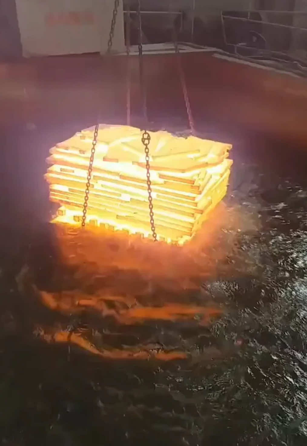 This image shows a unique method of cooling down a hot furnace: a good old-fashioned cold water bath. It's a simple yet effective approach, and it certainly makes for a dramatic visual.