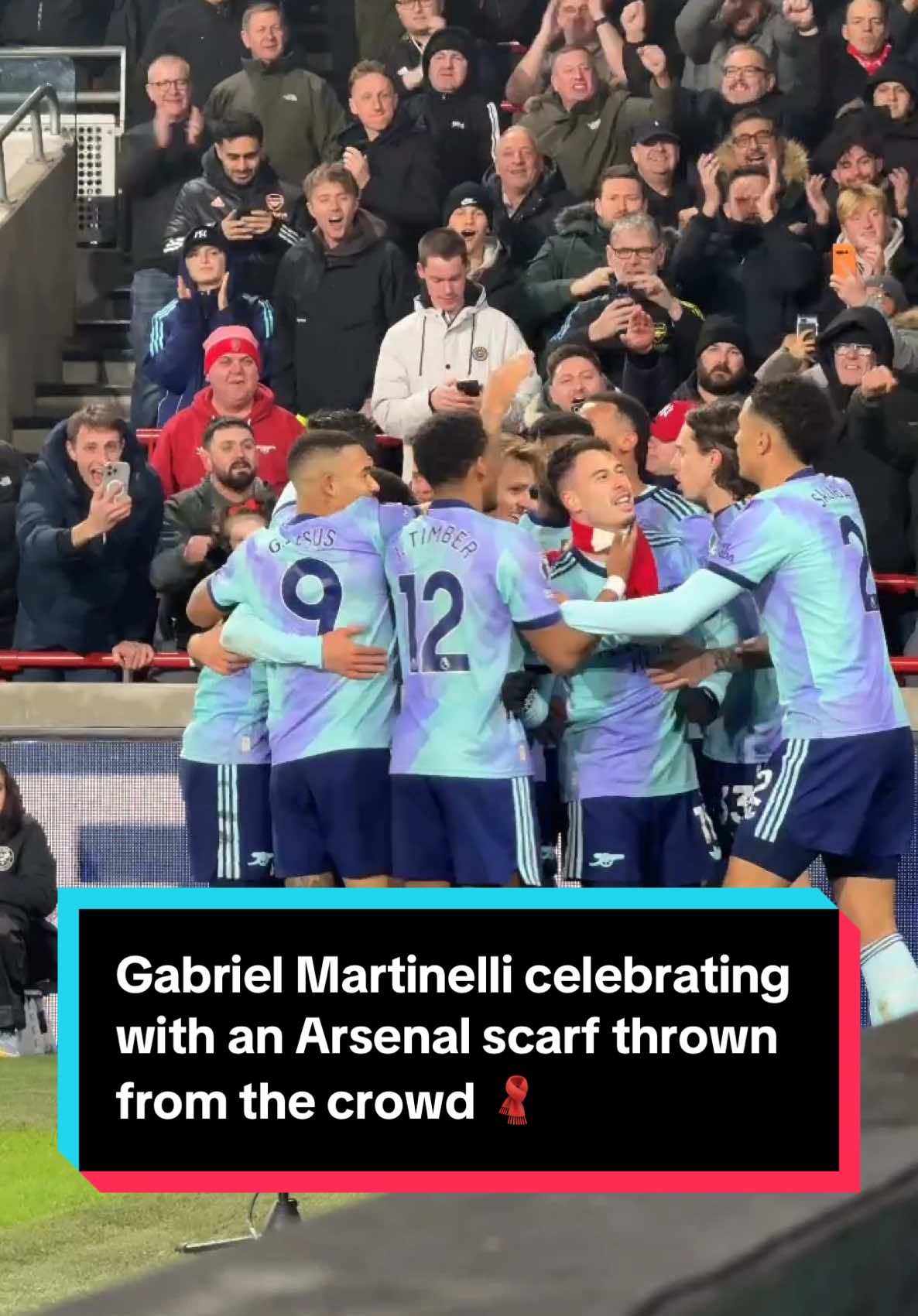 Gabriel Martinelli celebrating with an Arsenal scarf thrown from the crowd 🧣