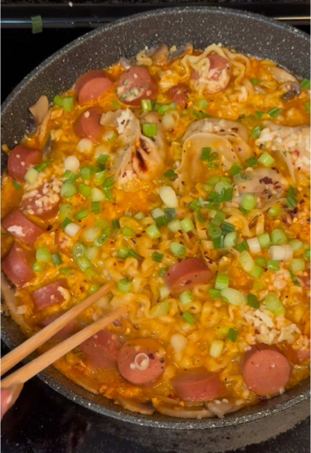 Late Night Ramen 🍜  Obsessed with this sound! ☠️ . . Recipe  ⬇️  . . 	1.	Sauté mushrooms with salt, pepper, and garlic. 	2.	Add water, ramen noodles, and seasoning packet. 	3.	Add toppings like chicken sausages and frozen dumplings. 	4.	Sprinkle chili flakes if desired, then melt mozzarella cheese. 	5.	Garnish with spring onions and enjoy! . . #buldakramen #buldakcarbonara #latenightramen🍜 #squidgamenetflix #squidgame2 #ramen #fyp 