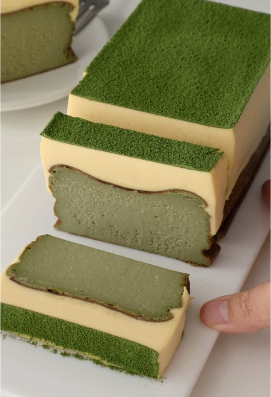 🍵 Matcha Tiramisu Basque Cheesecake🍵   📝 Matcha Basque Cheesecake Layer: - Cream cheese: 300g   - Fine sugar: 70g   - Matcha powder: 8g   - Whole eggs: 3   - Heavy cream: 150g   - Cornstarch: 10g   📝 Tiramisu Layer: - Raw egg yolk: 1   - Fine sugar: 30g   - Mascarpone cheese: 110g   - Heavy cream: 160g   - Milk: 60g   - Gelatin sheets: 10g #tiramisucake 