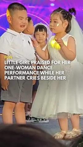 #ICYMI: A young girl in China turned a potential performance disaster into a viral moment of determination.   During a Children's Day school performance in Shandong on 31 May, the girl's partner broke down in tears on stage, likely from stage fright. But instead of faltering, she powered through solo, sticking to the choreography without missing a beat.   At one point, her lips quivered as if she might cry, but she held it together like a champ. 🥹 Netizens were moved by her perseverance, with one commenting, 