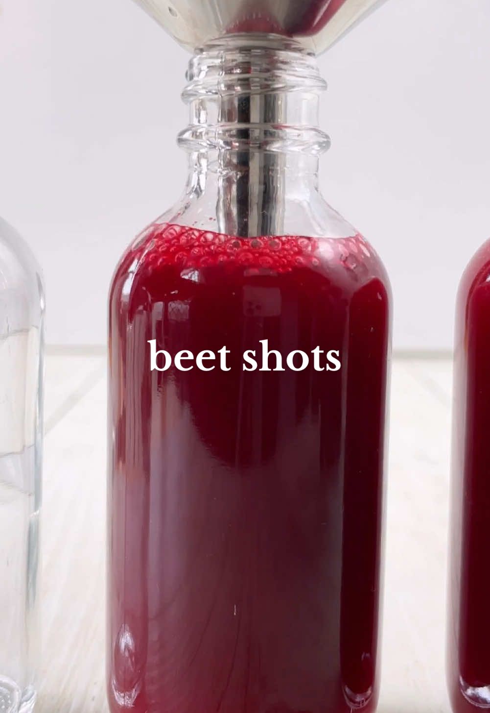 BEET SHOTS ❤️‍🔥 Let’s save money AND make energy boosting shots!! Win win 😌   Often juice shots are super expensive at cafes but here I spent only a few dollars on produce and made a whole weeks worth of shots! Yes you can make this in both a juicer and blender as I’m showing you here AND even save all of the leftover pulp for muffins or protein balls (or for your compost!).  Apparently theres actually studies and research backing up beets and their endurance boosting effects which is also super cool. Aside from its health benefits I promise it tastes delicious and is such a great way to kickstart your mornings! ✨ [Makes x10 60mL/2oz shots] Ingredients 2 apples  2 beetroots (add more if you don’t mind the taste!) 2 carrots 1 cup water (if using blender) Optional: lemon, ginger (I didn’t use either but I think ginger would be delicious in this) Method:  1. If using a juicer, simply add all of the produce into your juicer. If using a blender, add the water and blend well then strain until smooth.  2. Transfer into shot glasses and enjoy! Alternately, you can store all the juice in one big jar and pour it out as needed. Not gonna lie I could probably drink the entire thing in one go but I love spacing it out so I have a bit to drink every morning! Enjoy 💦 NOTE: Ideally best consumed within 3-5 days. You can also freeze them and thaw out as needed so they last longer (just don’t fill up the bottles too high up OR freeze into large silicone ice cube trays).  #vegan #plantbased #EasyRecipe #healthyrecipe #beet #beetshot #juice #juicerecipe #health #juicing #healthyfood #healthhack #beetroot #beetjuice #healthyrecipes