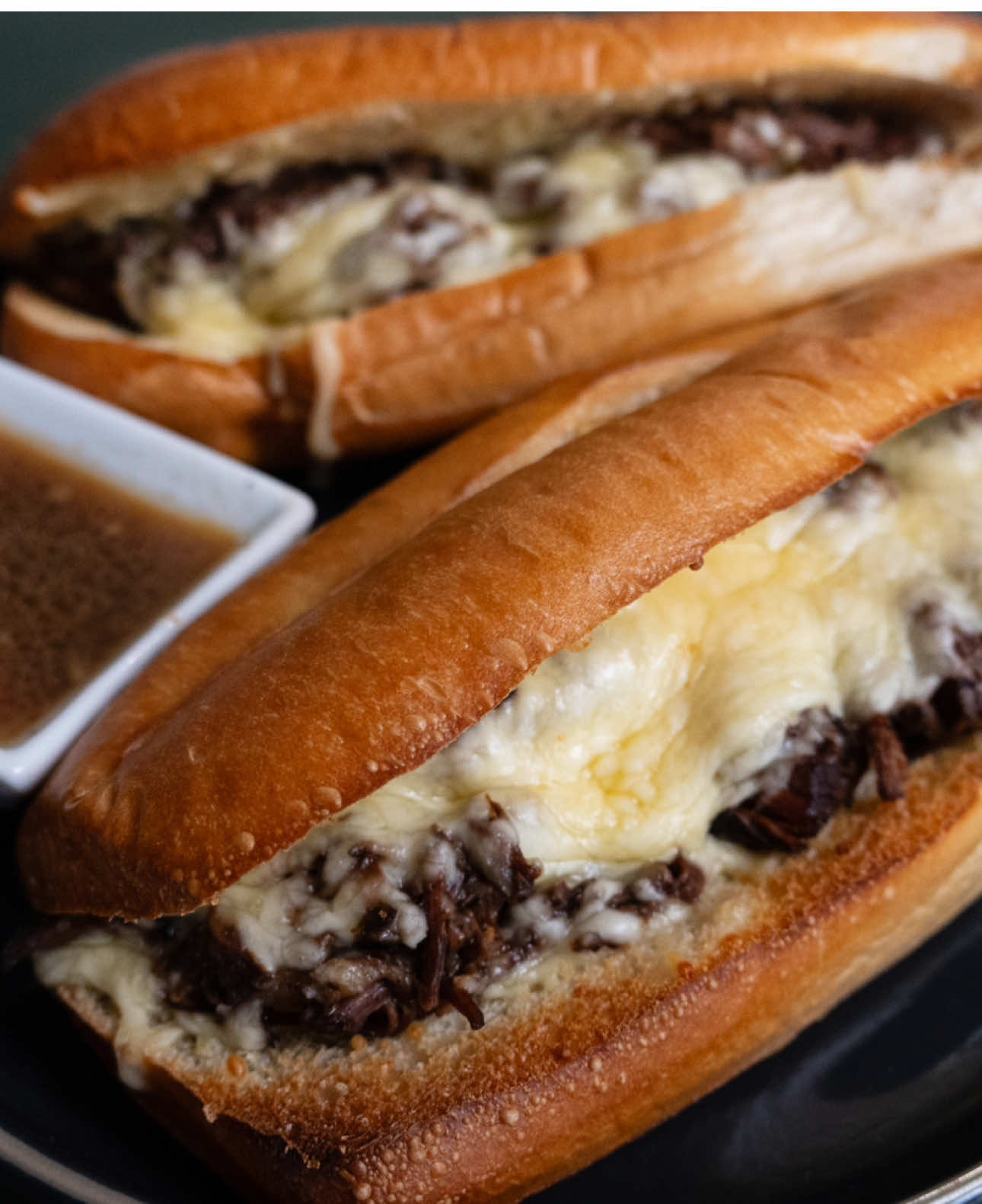 French Dip Subs 4-6lb Chuck Roast 1 Chopped Onion 2 tbsps Worcestershire sauce 2 tbsps minced garlic Sub rolls White American or Swiss cheese slices 3-4 cups beef broth  2 packets aus jus mix Salt pepper garlic seasoning to taste Instantpot  Season chuck roast on both sides with salt pepper and garlic seasoning, sear on all sides and remove Toss in chopped onions, chopped garlic, Worcestershire sauce and beef broth deglazing the bottom of the pot Add aus jus packets and mix before placing beef back in and closing up Pressure cook 2 hours Remove meat and shred before putting back in pot with broth Slice open bread and build your sandwiches, I put mine under the broiler to toast it up and melt the cheese Serve with a cup of the broth for dipping Crockpot Season chuck roast on both sides with salt pepper and garlic seasoning, sear on all sides and remove from pan In same pans cook onions til translucent and add chopped garlic, Worcestershire sauce, 2 aus jus packets and stir letting cook for a few seconds before adding beef broth to deglaze pan Place seared chuck roast in crockpot and pour broth mixture over the top, cover and cook onions low 6-8 hours  Remove beef and shred before returning it to the broth Slice open bread and build your sandwiches, I put mine under the broiler to toast it up and melt the cheese Serve with a cup of the broth for dipping #frenchdips #instantpotrecipes #EasyRecipe #holmescooking 