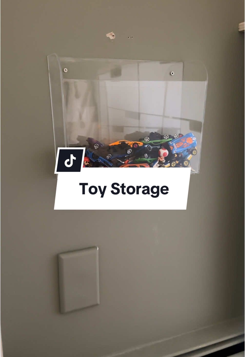 I looked for a while for something that could house our hot wheels and this acrylic wall pocket works perfectly! Sharing in case your kiddos were gifted a bunch of hot wheels for Christmas and you have no where to put them! #toystorage #hotwheels #playroom #playroominspo #toyorganization #acrylicstorage #playroomdecor 