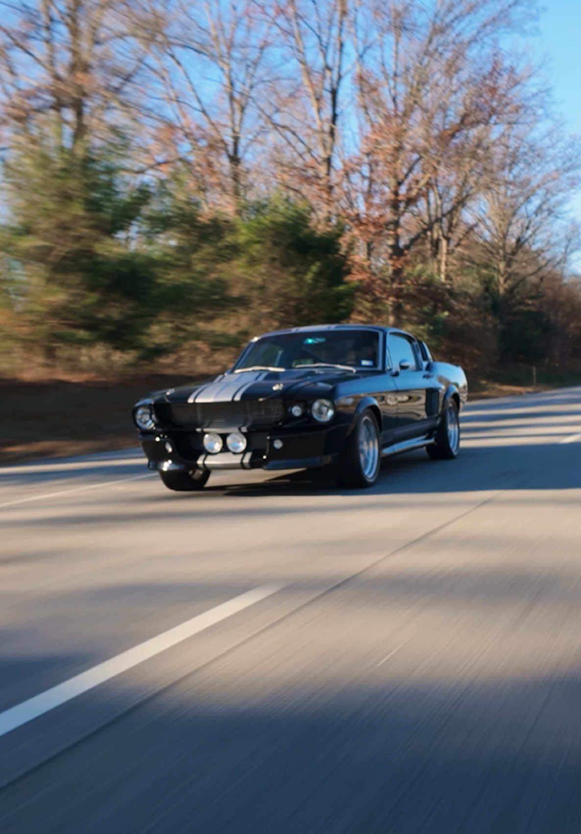 FOR SALE: 1-800-562-7815 at www.noreserveclassics.com | Timeless design, endless thrills with our ''Black Magic'' a 1968 Ford Mustang Fastback GT500E Supersnake Restomod! The 1968 Ford Mustang GT500E is an iconic symbol of American muscle, blending vintage aesthetics with modern performance enhancements. Powered by a legendary 428 Big Block engine and featuring a Cobra Air Cleaner, Edelbrock EFI system, and advanced cooling and drivetrain systems, it delivers impressive power and drivability. Its striking appearance is defined by the Full GT500E Kit, Raven Black paint with Gray Stripes, LED lighting, and Shelby American Racing Wheels. Inside, the cabin combines luxury and performance with Pro Car Leather Seats, a Cobra Wood Steering Wheel, Bluetooth-enabled Retro Sound Radio, and premium audio. The Mustang's rare Factory S Code pedigree, 5-speed Tremec transmission, 4-link suspension, and Wilwood disc brakes ensure superior handling and control, while the MagnaFlow exhaust adds to its commanding presence. This exceptional vehicle is a true testament to the Mustang legacy and automotive craftsmanship.