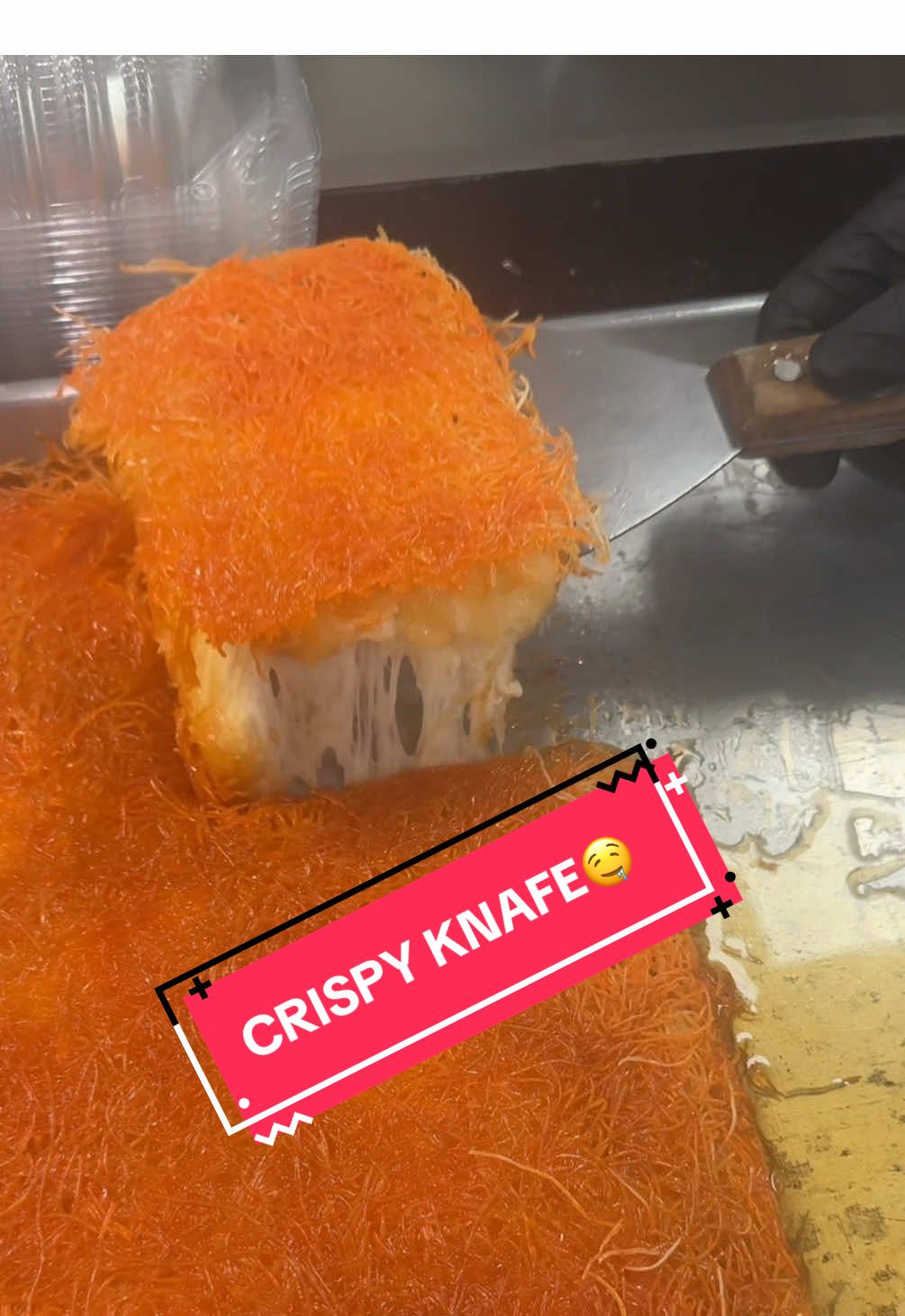 Filling up an order for our crispy cheesy knafe! Come get yours fresh today! #crispy #knafeh #orange #cheese #sweetie #duabi #cheesestretch #delicious #good #foodtiktok 