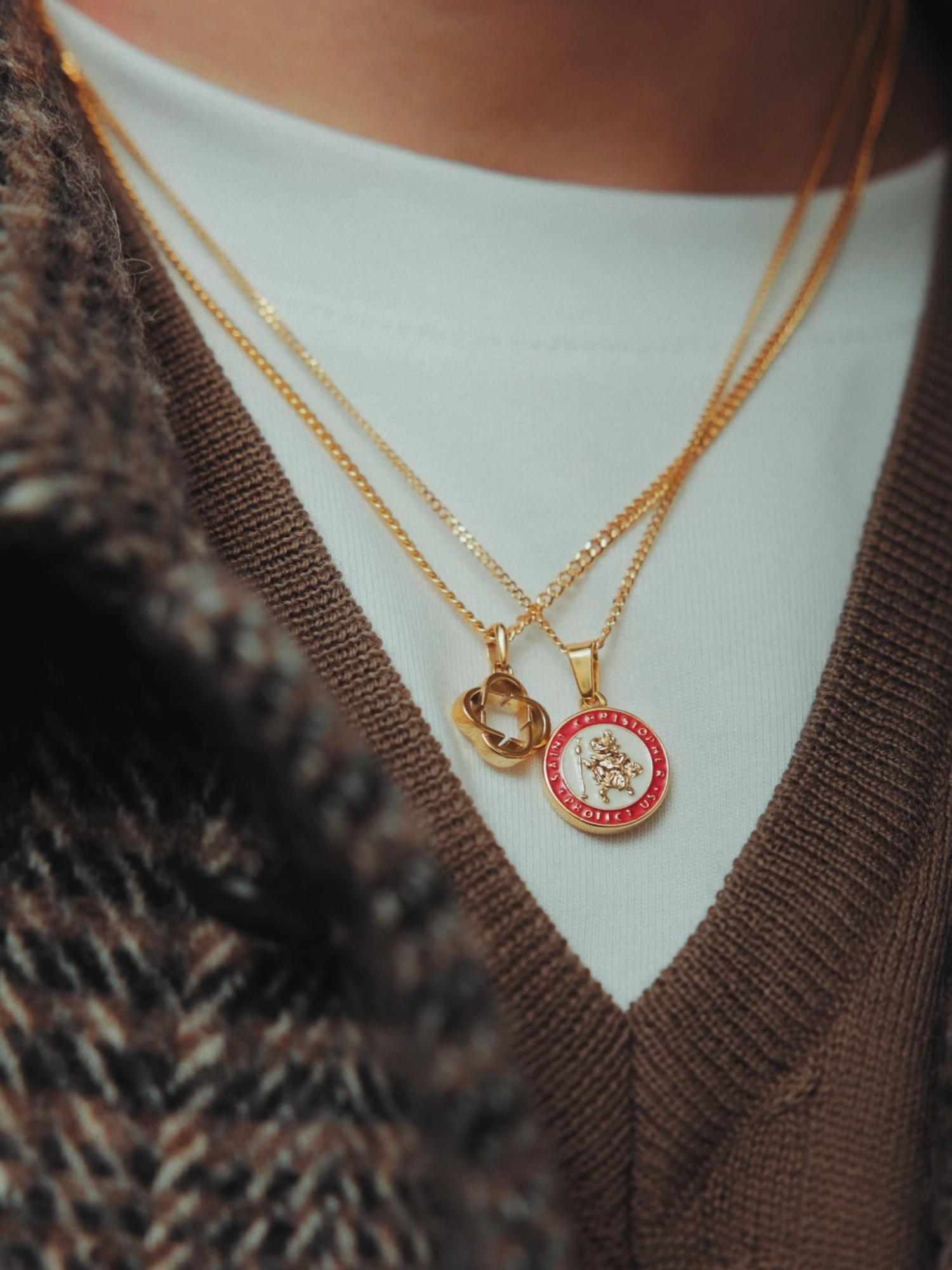 Gold accents, timeless style. Featuring the Enamel St. Christopher Pendant, CRAFTD Logo Pendant, and a curated stack of CRAFTD rings. Effortlessly for the season.