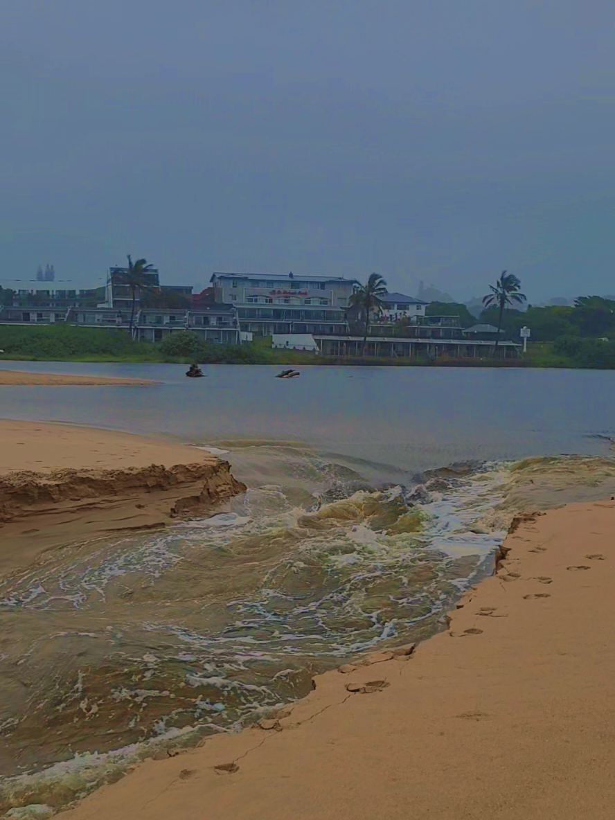 🌊🚨 Witnessed nature's raw power today at St. Michael's Beach! 🌊 The river, swollen from heavy rains, broke through into the crystal blue sea, unleashing a massive surge. Incredible to see such energy in action! 🌧️   Stay safe, South Coast friends, as we face these severe weather conditions. Always prioritize safety and avoid flooded areas!   📅 **6 January 2025**   📍 **St. Michael's Beach, KZN**   #KZNWeather #StMichaelsBeach #Flooding #HeavyRains #SouthAfrica #NaturePower #StaySafe #WeatherUpdate #RiverBreakthrough #SevereWeather #KZNRain #SouthCoast #NaturalPhenomenon #WeatherWarning #KZNFloods 