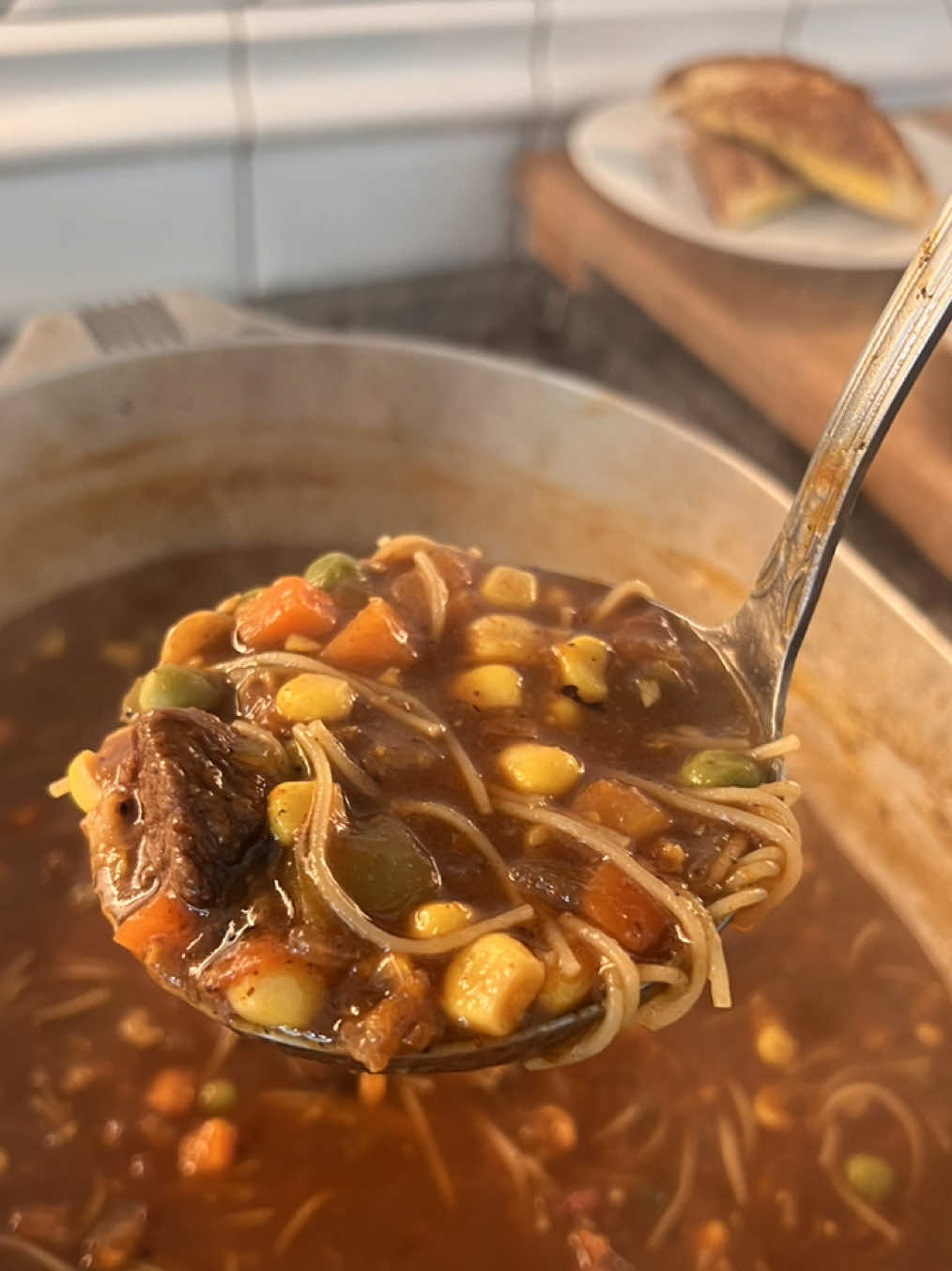 Beef & Veggie Soup! 🥣 🌽🥕🧅✨ Ingredients 	•	2 lbs beef shoulder or chuck roast, cut into bite-sized pieces 	•	1 tbsp BritsCookin Cajun seasoning (for roast) 	•	1/2 tsp black pepper (for roast) 	•	1 onion, diced 	•	1 bell pepper, diced 	•	2 tbsp minced garlic 	•	36 oz spicy hot V8 juice 	•	48 oz water (plus 2 more cups later) 	•	1 can (15 oz) cream of corn 	•	1 can (14.5 oz) fire-roasted diced tomatoes 	•	2 cups diced potatoes 	•	2 cups frozen corn 	•	2 cups frozen peas and carrots 	•	1 cup vermicelli egg noodles Seasonings for soup: 	•	1 tbsp chicken bouillon powder 	•	1 tbsp BritsCookin Garlic & Herb seasoning 	•	1/2 tsp cayenne 	•	1/2 tsp black pepper 	•	2 bay leaves Instructions 	1.	Cut beef into bite-sized pieces and season with Brit’s Cookin Cajun seasoning and black pepper. 	2.	Brown the beef in a heavy-bottom pan over medium heat. 	3.	Add diced onion and bell pepper. Cook until tender. 	4.	Stir in minced garlic and cook for 1 minute. 	5.	Deglaze the pan with a small amount of water, scraping the browned bits off the bottom. 	6.	Add V8 juice, 48 oz water, chicken bouillon powder, Brit’s Cookin Garlic & Herb, cayenne, black pepper, and bay leaves. 	7.	Stir in cream of corn and fire-roasted diced tomatoes. 	8.	Simmer the soup for about 1 hour, OR until the beef is tender. 	9.	Add diced potatoes, frozen corn, peas, carrots, and 2 more cups of water. Cook until potatoes are tender. 	10.	Add vermicelli egg noodles and cook until noodles are done. 	11.	Serve warm and enjoy! #creatorsearchinsights #easyrecipe #whattomakefordinner 