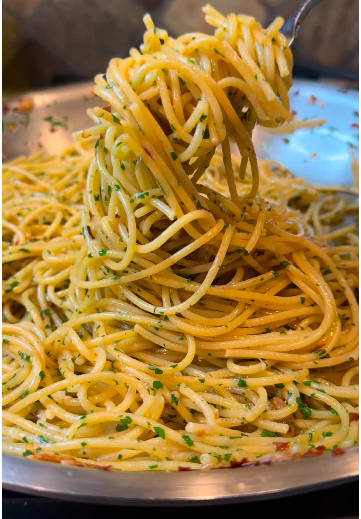 The Bougiest 10 minute struggle meal ever after a late night going out is for sure Spaghetti Aglio e Olio 🍝 It’s easy to make with just a few simple ingredients in just about 10 minutes. You can never go wrong with this dish! 🤤 Spaghetti Aglio e Olio Ingredients 1 tsp kosher salt (for pasta water) 1 lb dried spaghetti 1/3 cup extra virgin olive oil 8 large garlic cloves, thinly sliced 1 tsp crushed red pepper flakes 1/2 cup minced fresh parsley 1 cup freshly grated Parmesan cheese Instructions 1. Cook the Spaghetti 1. Bring a large pot of salted water to a boil. 2. Add the spaghetti and cook according to the package instructions. 2. Prepare the Sauce 1. Heat the olive oil in a large, light-colored pan over medium heat. 2. Add the garlic and cook, stirring frequently, until it begins to turn golden (about 1-2 minutes). 3. Stir in the crushed red pepper flakes and cook for an additional 30 seconds. 4. Turn off the heat. 3. Combine Pasta and Sauce 1. Add the spaghetti directly from the pot into the pan with the garlic and chili oil. 2. Stir in a few tablespoons of the pasta water as needed to coat the spaghetti evenly. 4. Finish and Serve 1. Toss in the minced parsley and freshly grated Parmesan cheese. 2. Mix well to combine, letting the pasta sit for a few minutes to absorb the flavors. 3. Serve warm, with extra Parmesan on the side. #pasta #spaghetti #italianfood #EasyRecipe #foodtiktok #FoodLover 