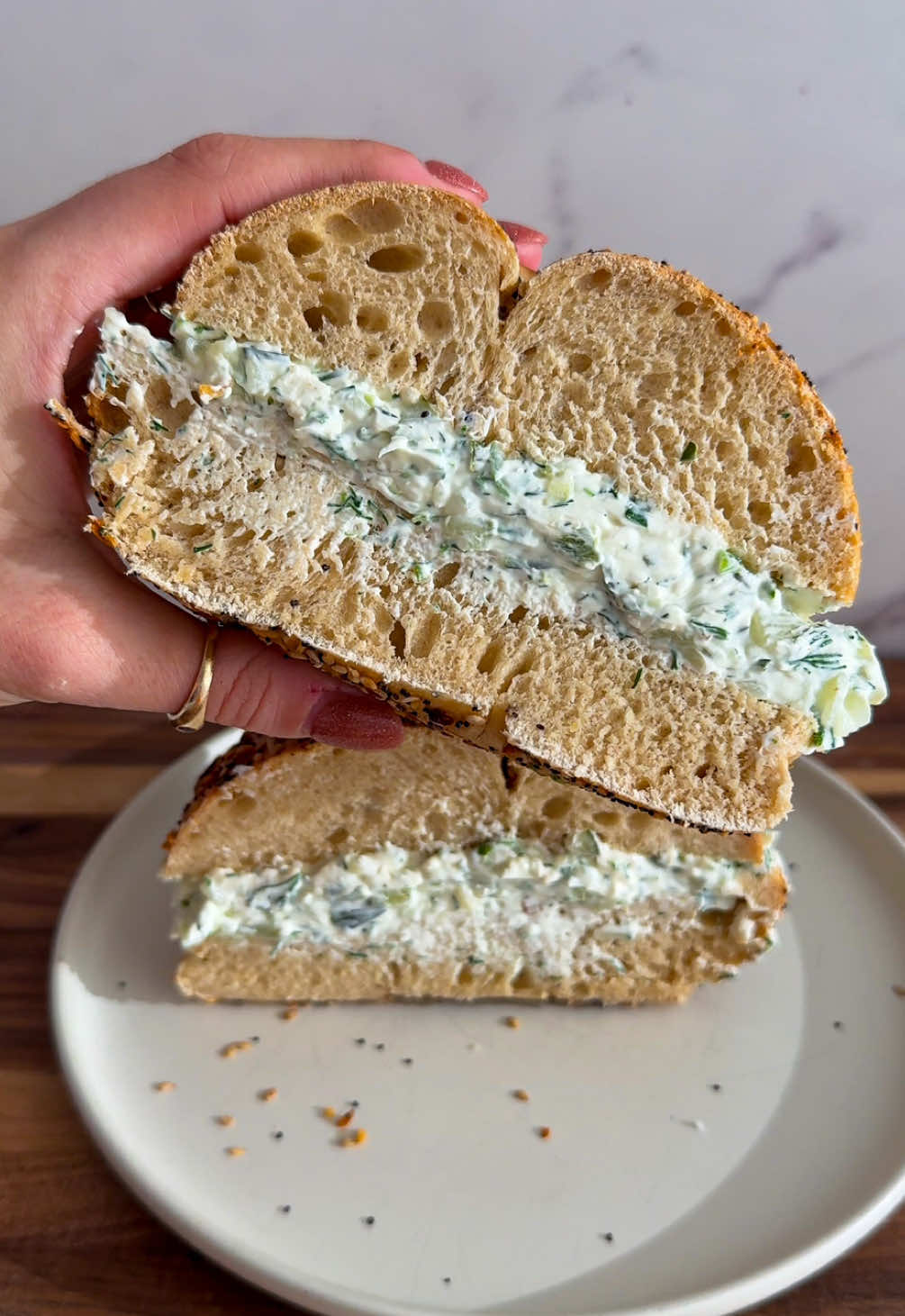 It's #trendingtuesday and @Alexa Santos is making Dill Pickle Cream Cheese 🥯🥒 inspired by @GrilledCheeseSocial  Get the recipe below and keep tagging #feedfeed for a chance to be featured. INGREDIENTS: 1 cup cream cheese 2 Kosher dill spears 5 dill pickle chips Small bunch fresh dill 3 scallions 1 teaspoon garlic powder 1 teaspoon Kosher salt RECIPE: 1. Add all ingredients to a cutting board. Use a sharp knife to chop all ingredients and mix together. #EasyRecipe #pickles #bagels 