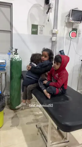 A Palestinian child is seen comforting her little sister at Al-Awda Hospital in Deir Al-Balah, Gaza. The siblings were brought to hospital after Israeli strikes on Bureij refugee camp. The fate of their parents remains unknown.