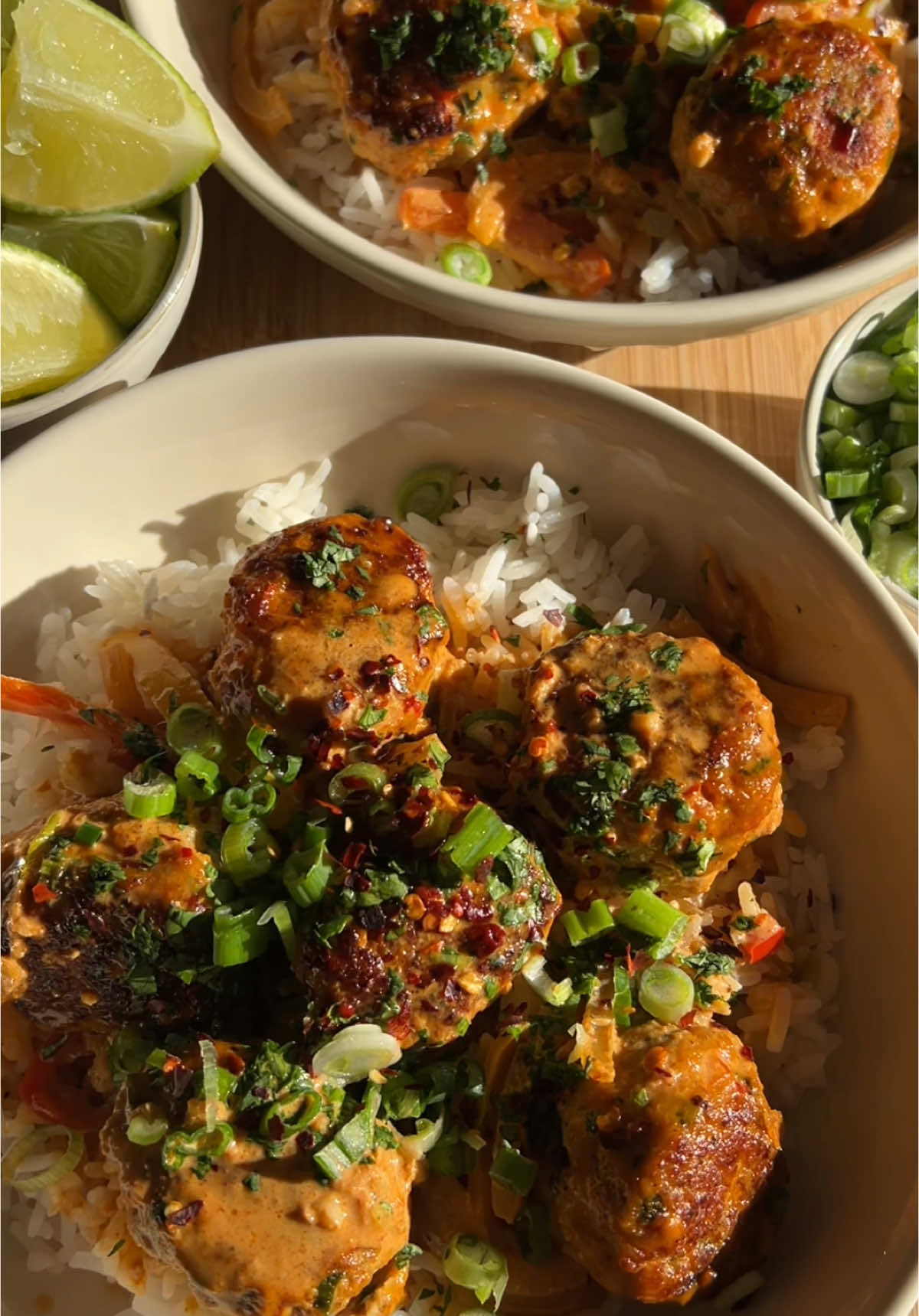 THAI CHICKEN MEATBALLS 🌶️ The perfect 30 minute weeknight dinner that the entire family will love - Thai Chicken Meatballs! 👏🏼 These are dairy-free and can easily be made gluten-free (use GF breadcrumbs and soy sauce) so they are adjustable based on your diet. Serve them over rice with a big squeeze of fresh lime juice, cilantro, green onions, red pepper flakes & enjoy! INGREDIENTS (4-5 servings) Meatballs: - 1lb ground chicken - 1/2 red bell pepper, finely diced - 1/4 cup green onions, diced - 2 tbsp cilantro, diced - 2 cloves garlic, minced - 1 tsp freshly grated ginger - 2 tbsp soy sauce - 1 egg - 1/4 cup breadcrumbs - 1/2 tsp salt - 1/2 tsp pepper  - 1/4 tsp red pepper flakes Sauce: - 2 tbsp butter - 1 yellow onion, julienned - 1 red bell pepper, julienned - 4 cloves garlic, minced - 1 tsp freshly grated ginger - 2 tbsp red curry paste - 1 can unsweetened full fat coconut milk - 3 tbsp soy sauce - Toppings: green onions, lime wedge, fresh cilantro and red pepper flakes - Rice to serve DIRECTIONS: 1. Add all meatball ingredients in a bowl and mix until well combined. Using a cookie scoop or large tablespoon, scoop and roll into uniform balls 2. In a large pan over medium heat, melt butter. Evenly space meatballs in the pan and sear for 3-4 minutes per side until golden brown, then remove from the pan (the meatballs will finish cooking in the sauce, so it is ok if they aren't fully cooked through) 3. Add onion and bell peppers into the pan and saute for 4-5 minutes until soft and fork tender. Add minced garlic, fresh ginger and red curry paste and mix until the onions and peppers are evenly coated. 4. Add coconut milk and soy sauce and mix until well combined, then bring to a simmer 5. Once simmering, add meatballs back in and simmer for 10 minutes. Prepare the rice while the meatballs finish cooking 6. Serve the meatballs over rice with a squeeze of fresh lime juice, cilantro, green onion and red pepper flakes - ENJOY!