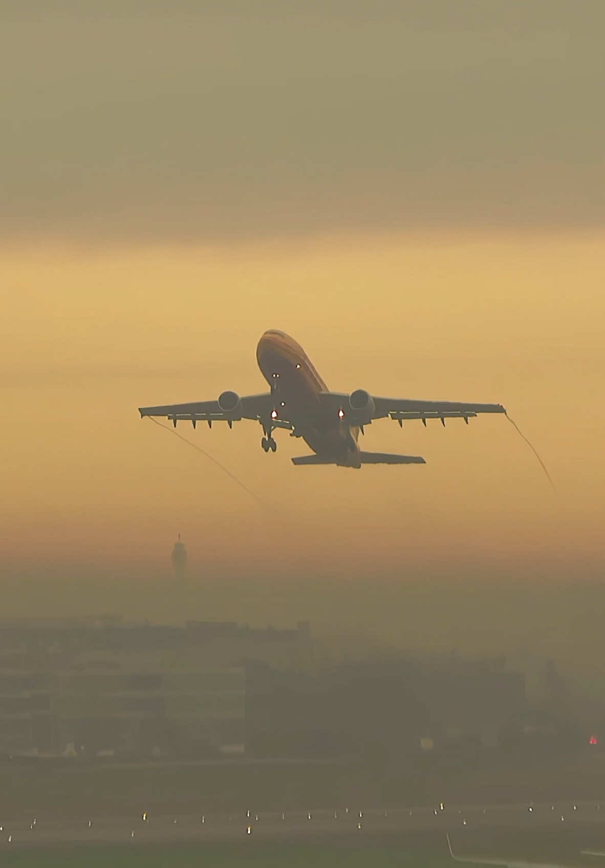 DHL Airbus A300-600F lifts off from a misty Heathrow with BT Tower silhouette in the background. #airbus #a300 ##dhl #heathrow ##planes ##takeoff 