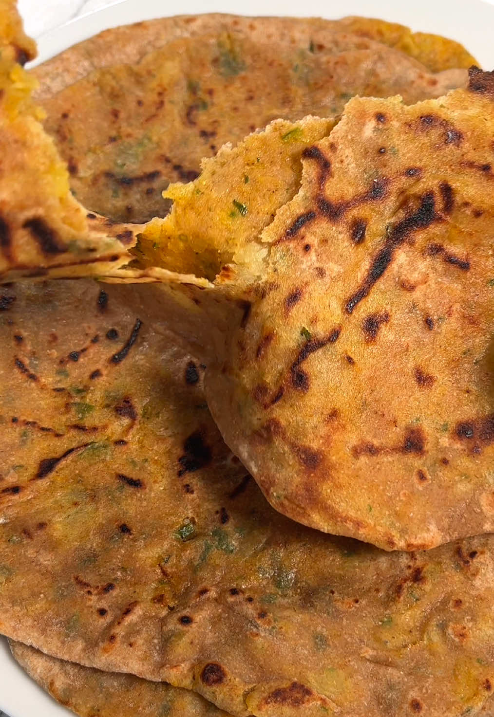 Stuffed Flatbreads from around the 🌍  Aloo Paratha 🇮🇳 | Recipe ⬇️  To a bowl add  -2 cups whole wheat flour (240 g), or more if needed -1/2 tsp salt -1 cup water, as needed Kneed until you have a smooth dough, cover and let it rest for 30 mins. For the filling, Peel and boil -3-4 potatoes (14oz, 400 g)  until fork tender. Mash them and then add -2 tbsp cilantro, finely chopped -1 tsp minced ginger -1 green chili, chopped (optional) Seasoning: -salt, to taste -1 tsp Garam Masala -1 tsp coriander powder -1 tsp paprika powder -1/2 tsp cumin powder And combine. Roll out a piece of dough and place the filling in the center. Close it and roll it out carefully. Place it on a hot pan. Cook both sides until golden brown with dark spots and brush both sides with oil. Serve hot with chutney and enjoy :)  ⠀ #veganmeal #indianrecipes #veganerezepte #indiancooking #vegan #veggie #veganrecipes #indianfoodie #alooparatha #indianfood #veganessen #veganes #vegetarianrecipe #indischessen #plantbasedfood #indischeküche #veganfood #veganrecipe #paratha #veganfoodie #veganfoodporn #veganindianfood #vegetarianrecipes #flatbread #veganindian #vegetarian #veganeernährung #stuffedbread #indisch #vegandinner #recette 