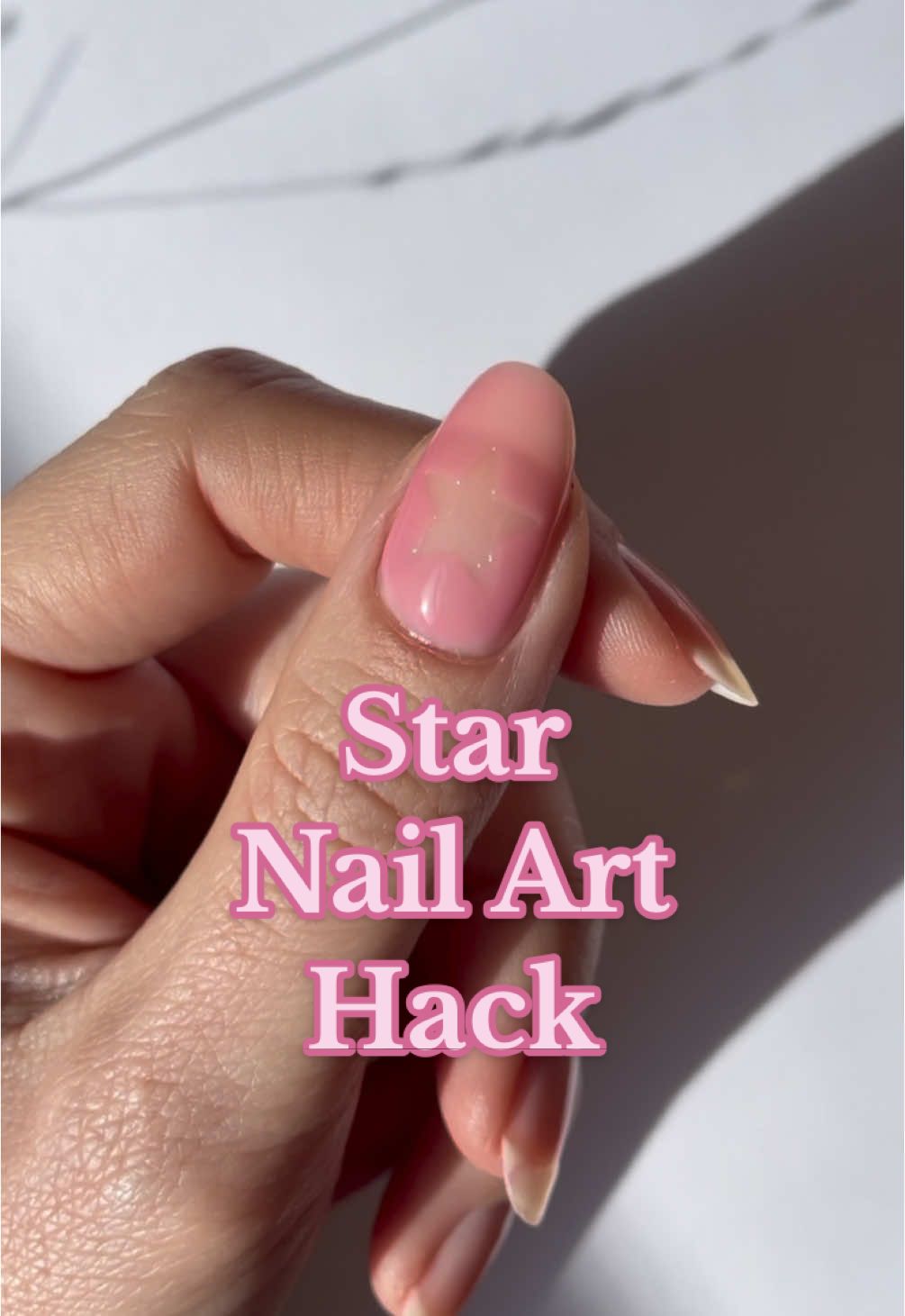 The trick is to use a good quality sticker, and make it a little less sticky before applying it to the nail. This is SO much easier than free handing a negative space star. #naturalnails #nailtutorial #nailsartvideos 