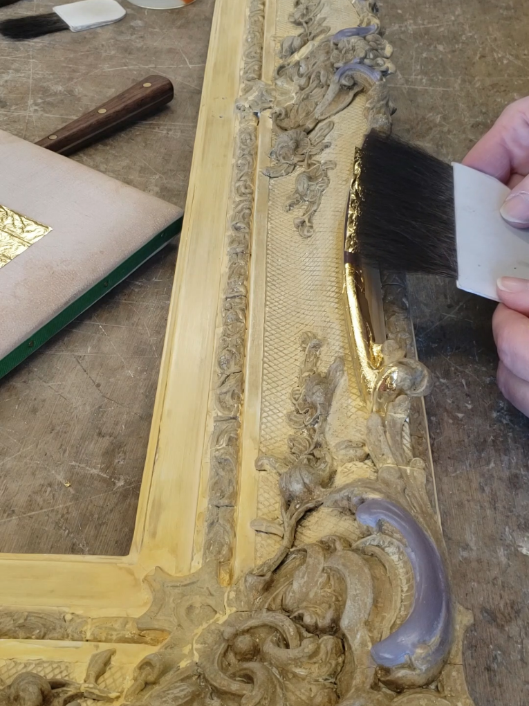 Water gilding with 23.75ct gold leaf on an English picture frame. 