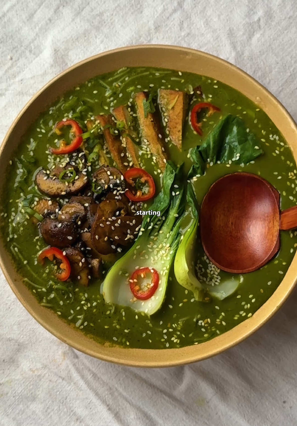 THAI GREEN NOODLE SOUP 🍜 starting the new year healthier can be hard. but relying on nutritious recipes that we love is the best way to begin as we mean to go on… take my Thai Green Noodle Soup, made with fresh produce that’s packed with fresh flavours + nourishing nutrients. a broth that’s topped with seared tofu, mushroom + pak choi, I picked up all my fresh veg, herbs + ingredients for under £15 💰 with this recipe, you can either feed 4 OR have lovely leftovers in the fridge for the week. so if you want to start 2025 with wholesome recipes that are good for your body + wallet, give this one a go. I’ve written my full recipe below - so enjoy. and as always, let me know if you give it a go 💚 * part of a paid partnership * INGREDIENTS (serves 4) BROTH 15g fresh mint 15g fresh coriander 200g spinach 5 garlic cloves 1 small knob of fresh ginger 1 bunch spring onion (use whites for broth + greens for topping) 2 limes 2 tbsp dark soy sauce 400 ml coconut milk 1 litre boiling water (more for more broth - adjust seasoning accordingly) 2 vegetable stock cubes 1 tsp miso paste (optional) Salt + sweetener of choice (to taste) Oil TOPPINGS 400g smoked tofu 250g chestnut mushrooms 250g pak choi 1 red chilli 450g rice noodles Toasted sesame seeds METHOD 1. In a food processor/blender, peel + add the garlic, ginger, fresh herbs + spinach (I blanched this first). Loosen with a splash of water if needed, then blitz. 2. Add the soy sauce, 100ml coconut milk, juice of 1 lime, then blend again. Season to taste with salt + sweetener of choice if needed. 3. Pour into a pot, then dissolve 2 veg stock cubes in 1 litre of boiling water. Add to the pot, bring to a boil then simmer on a low heat for 10-15 mins. Add more boiling water for more broth, seasoning to adjust as is required. 4. Prepare your toppings - I sliced the tofu + seared on a medium-high heat in oil, then seasoned with a splash of soy sauce. Do the same for the mushrooms + blanch the pak choi. 5. Cook your noodles, then place in a bowl. Top with ladles of the green broth, then add your toppings. Finish with spring onions, chillis, sesame seeds + enjoy! #soup #noodlesoup #thaifood #healthyrecipes #comfortfood 