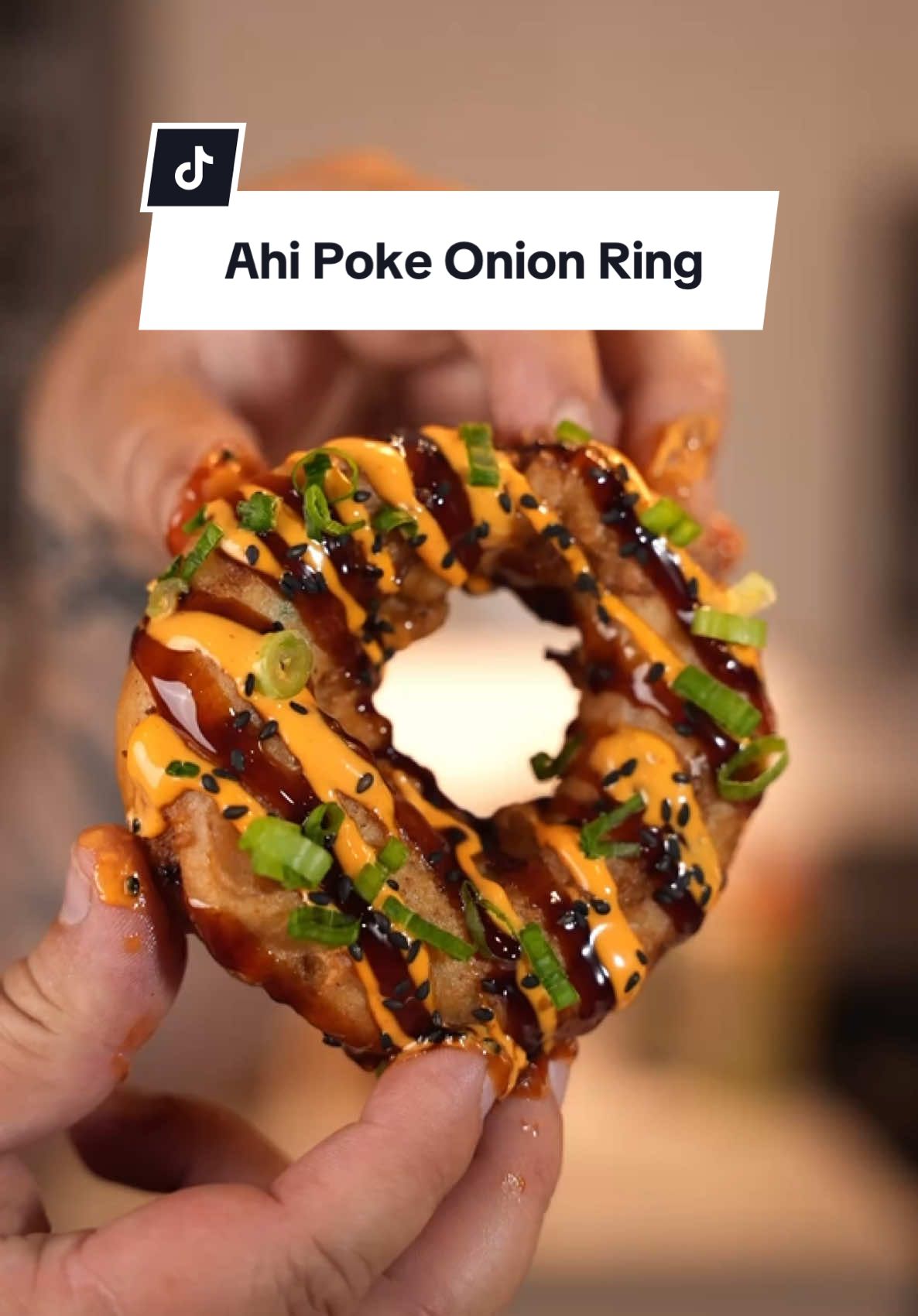 Ahi Poke Tempura Onion Rings 🤯 Recipe Below ⤵️⤵️⤵️ One of my followers sent me a message and never talked to her before and she drops this idea and I had to bring it to Life for Her! @photokat1212 🙏🏼 Makes 10 Large Rings Prep Time: 10 minutes  Cook Time: 10 minutes  Ingredients:  1lb Ahi Tuna  1/2 Bunch Green Onions  1 Large Avocado  4 Tbsp Mayo 1 oz FYR RED @fyrstarter  1 oz Sesame Oil  1 oz Soy Sauce  5 Large White Onions  12 oz Tempura Batter  1 1/2 Cups Cold Water  1 Tbsp Canola Oil  1 1/2 Cups Fry Oil  1 oz Unagi Sauce (Eel Sauce)  1 oz Spicy Mayo  1 Tbsp Black Sesame Seeds For the Rings:  1. Chop ahi tuna, green onions, and avocado and put in a mixing bowl 2. Add mayo, FYR Red, sesame oil, and soy sauce and combine all ingredients  3. Next cut onions about 1/2 inch thick and use the center of the onion for the largest rings to stuff 4. Use the largest ring and use 3 rings down so you can stuff the onion 5. Stuff the onion with the Ahi Poke mixture on a non stick sheet 6. Put the rings in the freezer for 15 minutes or overnight to make sure it is frozen (this will help not over cook the ahi and will be easier to work with) 7. Add tempura batter, cold water, and oil in a mixing bowl and mix well for 2 minutes  8. Dip your rings in the tempura batter and fry in 375 degree oil until golden brown on each side For the Garnish:  1. Drizzle unagi sauce, spicy mayo and top with black sesame seeds and green onion   Single Burner @gasoneusa 🔥 Knife @thecookingguildshop 🔪 #ahi #poke #onionring #appetizer #Recipe