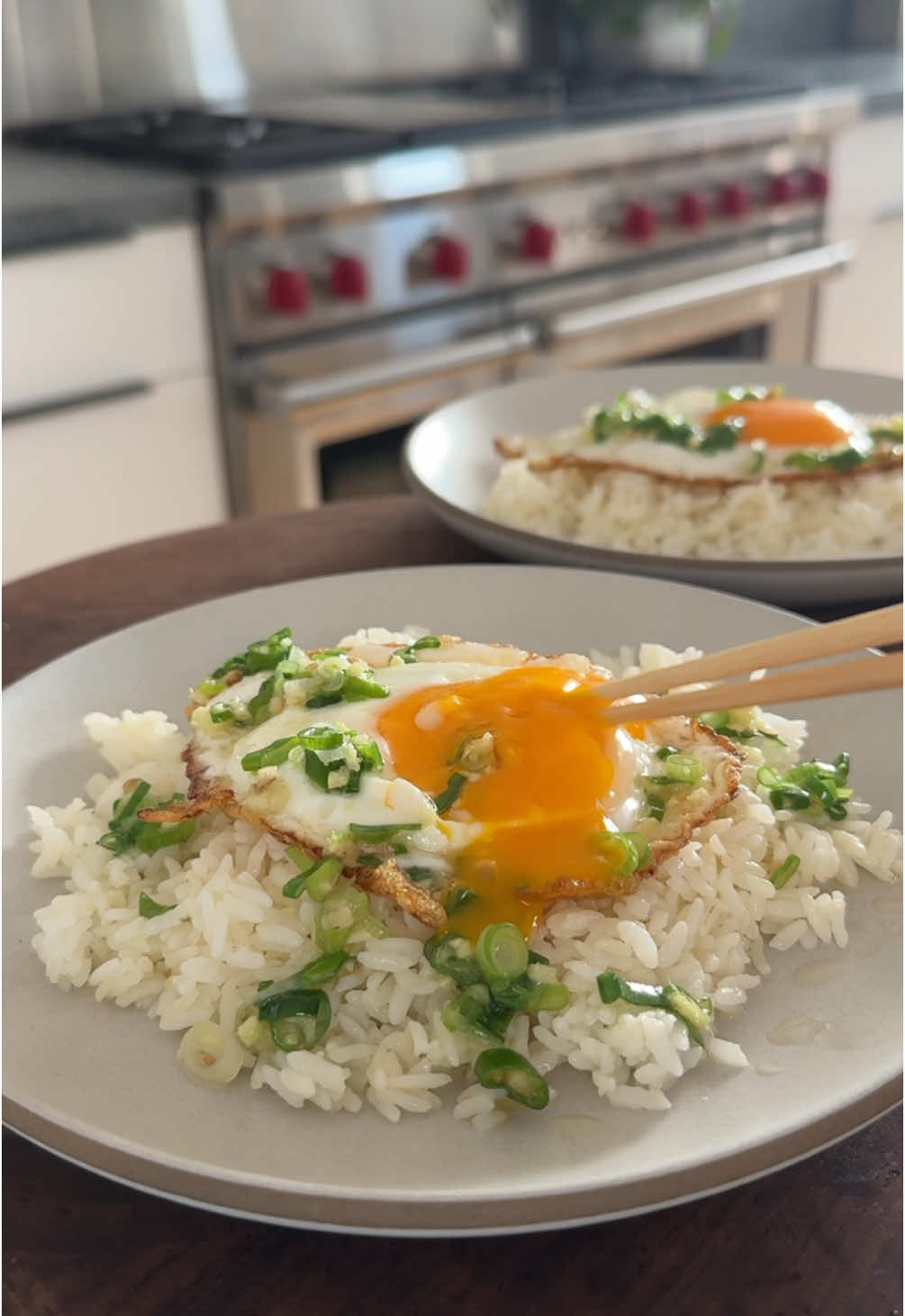 Seared scallion oil with eggs & buttered rice✨ Seared Scallion Oil:▪️3 Scallions, sliced very thin (2 oz)▪️2 Tbsp Minced Fresh Ginger▪️1/4 tsp Kosher Salt, plus more to taste▪️1/4 Cup Peanut Oil▪️2 tsp Sesame Oil▪️ Rice + Eggs:▪️2 Cups Cooked Jasmine Rice▪️1-2 Tbsp Butter, cut into small pieces▪️1 Tbsp Oil (any kind)▪️2 Eggs▪️ 🌱Vegan Modification: Sub in sautéed mushrooms for eggs, and plant based butter for butter 1️⃣ Place the scallions, ginger, and salt in a medium heat proof bowl. In a small saucepan, heat the peanut oil until it just starts smoking and reaches 400F on an instant read thermometer. Carefully pour the hot oil over the scallions and ginger. Mix and stir in the sesame oil. Let cool for a couple mins, then taste and add more salt if desired. (The sauce should have a nice salty zing.) 2️⃣ Mix the cooked jasmine rice with the butter until it melts, then cover to keep wam. 3️⃣ In a medium pan preheated over medium heat, add oil to coat the pan then add the eggs. Fry the eggs sunny side up with a sprinkle of salt until the white is set but the yolk is still runny. Option to tilt the pan, scoop up the hot oil with a spoon, and baste the top of the egg white to help it cook through. 4️⃣ Divide the rice onto plates and top each with a fried egg. Spoon on the seared scallion oil to taste (you may have some left over), and enjoy!  ⏲15 minute total prep + cook time . #maxiskitchen #EasyRecipes #recipesoftikok #healthyrecipes #recipeideas 