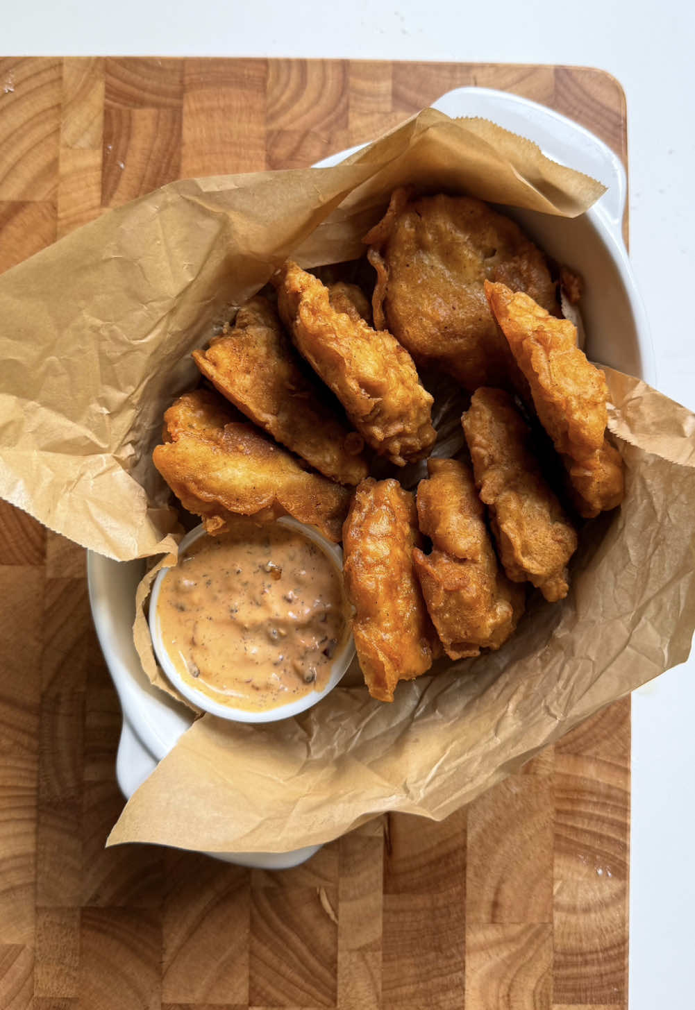 Crispy Chicken Nuggets with Hot Honey Ranch Yield: 25-30 nuggets Ingredients: For the Chicken: - 2 lb boneless chicken breast, minced - Salt, to taste - 1 tbsp garlic powder - 1 tsp black pepper - 1 tsp paprika powder - 2 eggs For the Coating: Dry Batter: - 1 cup all-purpose flour Wet Batter: - 3/4 cup all-purpose flour - 2 tbsp corn flour - 1 tsp baking powder - 1 cup water - Salt, to taste - 1 tbsp garlic powder - 1 tsp paprika powder For the Hot Honey Ranch: - 3 tbsp mayonnaise - 3 tbsp sour cream - 2 tbsp honey - 1 tbsp chili oil - 1-2 tbsp hot sauce - Salt, to taste - 1 tbsp garlic powder - 1 tsp dried dill Method: Prepare the Chicken 1. In a large bowl, combine the minced chicken, salt, garlic powder, black pepper, and paprika powder. Mix well. 2. Add the eggs to the chicken mixture and mix until just combined. 3. Grease your hands with oil to prevent the mixture from sticking. 4. Shape the mixture into nuggets and place them on a prepared baking sheet. Freeze for 1-2 hours or until frozen. Prepare the Coating 1. In a separate bowl, mix together the dry batter ingredients (all-purpose flour). 2. In another bowl, whisk together the wet batter ingredients (all-purpose flour, corn flour, baking powder, water, salt, garlic powder, and paprika powder). Add water and mix until a smooth batter forms. Fry the Chicken Nuggets 1. Heat about 2-3 inches (5-7.5 cm) of oil in a deep frying pan over medium-high heat. 2. Dip each piece of chicken first into the dry batter, then into the wet batter, making sure it's fully coated. 3. When the oil is hot, add a few pieces of the coated chicken to the oil (do not overcrowd). 4. Fry the chicken nuggets until they're golden brown and crispy, about 5-6 minutes. 5. Remove the fried chicken nuggets from the oil and place them on a paper towel-lined plate to drain excess oil. Prepare the Hot Honey Ranch 1. In a bowl, whisk together the mayonnaise, sour cream, honey, chili oil, hot sauce, salt, garlic powder, and dried dill until smooth. 2. Refrigerate the hot honey ranch until ready to serve. Serve the crispy chicken nuggets with the hot honey ranch dipping sauce. Enjoy! #chickennuggets #nuggets #crispychicken #Recipe 