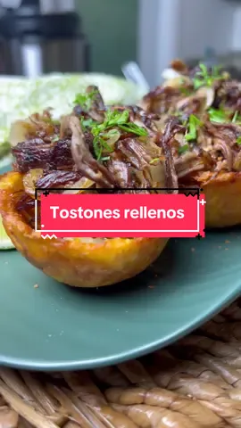 Tostones rellenos de vaca frita aka mini plantain cups filled with crispy beef 🤤 the lemon squeezer trick never fails! Ingredients 2 green plantains Oil for frying Vaca frita: 1 lb. of flank steak 1 ½ yellow onions, thinly sliced 2 tbsp. of freshly minced garlic 3 bay leaves 3 tbsp. of olive oil Juice of 2 limes Salt & pepper to taste Instructions Peel the green plantains and cut each one into three pieces, about 2 inches long. Heat oil in a fryer or pot to 350°F. Fry the plantain pieces for about 3-4 minutes, or until they are lightly golden. Remove and drain on a paper towel. Place a piece of parchment paper inside a lemon squeezer. Put a fried plantain piece on top of the parchment and cover it with another piece of parchment. Press down firmly to flatten the plantain into a cup shape. Second fry:Return the flattened plantain cups to the fryer at 350°F. Fry until golden brown and crispy. Remove and drain on a paper towel to absorb excess oil. Salt immediately. Fill the tostones cups with vaca frita or your protein of choice.  For the vaca frita: Place your steak, ½ an onion and bay leaves in your instant pot. Fill the instant pot with water until the meat is completely submerged. Set to Pressure Cook on high for 30 minutes. Once the time is up and the pressure has released from your instant pot, remove the meat & shred the beef. Add the minced garlic, salt and pepper to your beef. Add your thinly sliced onions to a sauté pan with olive oil. Over medium high heat, begin sautéing your onions & add your shredded beef and lime juice right over it.  Allow to cook untouched for 3-5 minutes per side to develop a crisp crust on the meat. Repeat and stir constantly until the meat is perfectly crispy.