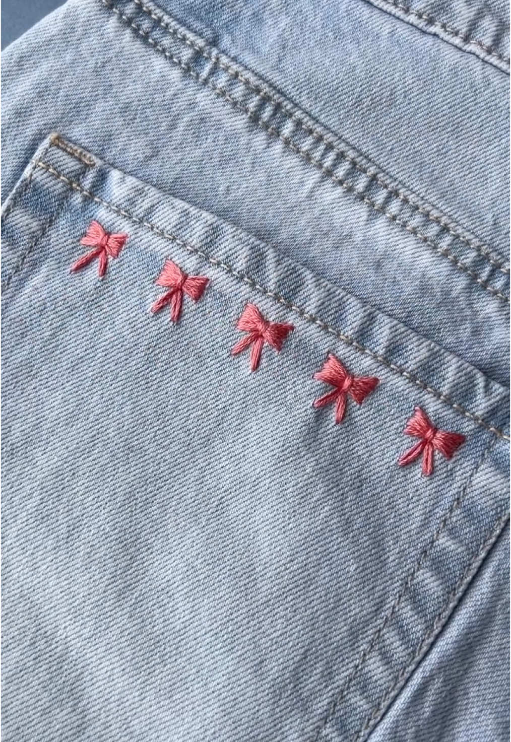 How cute is this pocket! I’m absolutely loving 🎀 designs at the moment. Here’s another simple way to stitch them. I used the existing seams on the denim to measure the gaps between each bow and to size them evenly 🩷 . . #embroideredbows  #embroiderytutorial  #upcycledclothing  #upcycledfashion  #embroideredflowers  #embroideredclothing  #embroidereddenim  #embroideredclothes  #embroideredflorals  #learntoembroider  #mindfulart  #slowstitching  #sewingproject  #embroiderypatterns  #bordadolivre  #createdtocreate  #diycrafts  #slowcraft  #dmcthreads  #dmcembroidery  #springflowers  #embroiderydesign  #beginnerembroidery  #embroiderywork  #denimembroidery  #sustainablefashion  #embroiderhappyhoops  #embroiderytutorial  #embroideryprocess