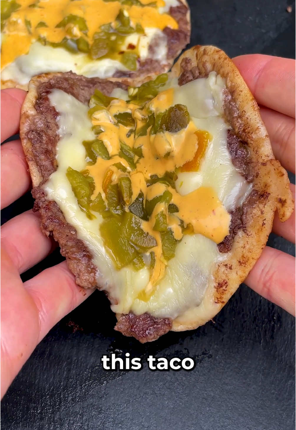 Would you call this a taco? A burger? or some sort of hybrid name I haven figured out yet? Drop your name suggestions below! INGREDIENTS 4 flour tortillas 8 slices of white American cheese  1 pound of ground beef separated into 4 balls  4 green chilis (preferably hatch chilis)  1/2 cup beef stock 1 tsp garlic and onion powder a pinch of salt and pepper FOR THE SAUCE 1/2 cup mayonnaise 1/4 cup sour cream 1/4 cup chipotle in adobo Juice of a lime 1 tsp of garlic and onion powder Salt and pepper to taste  Step 1 Lightly coat the chilis in oil and roast in the oven for 10 minutes at 450 degrees F. When they come out, add them to a ziploc bag and let cool and steam for 10 minutes. When they’re cool enough to touch, take off the skin and chop them.  Step 2 Add the chopped chlis to a saucepan or pot with beef stock, garlic and onion powder and salt and pepper. Cook on low heat until there is no more liquid.  Step 3 Add the ground beef to the tortilla and flatten it out. Place it on a hot skillet and press it down as hard as you can for 1 minute. Flip it over and add 2 slices of American cheese. Hit the pan with some water and cover it to let the cheese melt. After about a minute, uncover the pan and add the green chilis.  FOR THE SAUCE Combine all the ingredients in a blender until smooth. Season with salt and pepper.