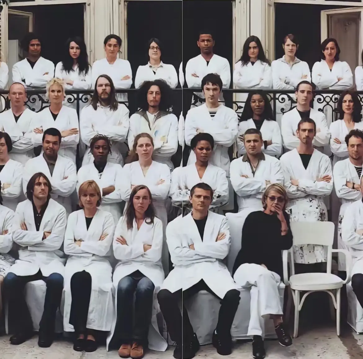 Margiela employees are required to wear white lab coats when working. This rule was put in place by Martin Margiela himself. Also, the empty chair in the first slide is symbolically reserved for Martin Margiela, who does not make public appearances.