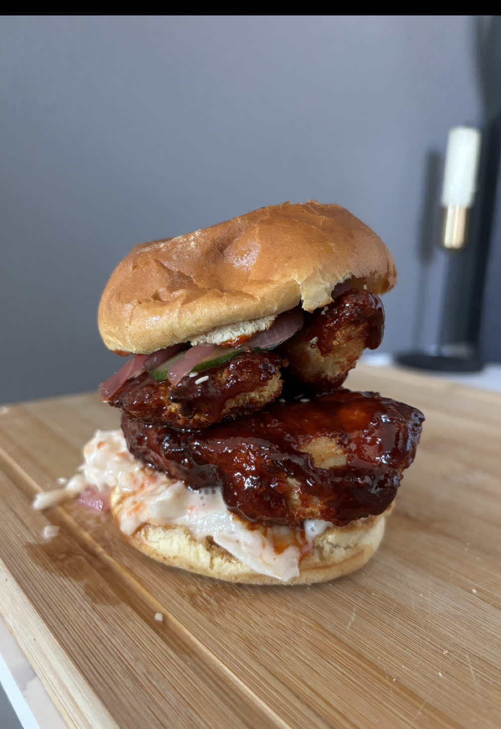 Flavours so good, they’d text back immediately😏 Welcome back to “Single, but cooking like someone’s falling for me tonight.” Who’s hungry? 👀😏 Korean Chicken Burger  •	2 chicken breasts (butterflied) •	2 egg whites •	100g breadcrumbs •	2 tbsp gochujang paste •	1 tbsp soy sauce •	1 tbsp rice wine vinegar •	1 tbsp honey •	1 tbsp garlic and ginger paste •	1 tsp sesame oil •.    2 brioche buns (toasted) •	Coleslaw	 •	Sriracha mayo •	pickled onions and cucumbers 1.	Preheat the air fryer to 200°C. 2.	Dip the butterflied chicken into egg whites, then coat with breadcrumbs. 3.	Air fry for 18 minutes, flipping halfway, until golden brown. 4.	Heat gochujang, soy sauce, rice vinegar, honey, garlic and ginger paste, and sesame oil in a pan for 1-2 minutes. 5.	Toss the crispy chicken in the sauce. 6.	Spread sriracha mayo on the toasted brioche buns. 7.	Layer with coleslaw, Korean-glazed chicken, and pickled onions and cucumbers. #koreanchicken #koreanbbq #burger #whoshungry #solodining #datenight #single #brioche #cooking #cookingathome #EasyRecipes #quickandeasy #dineinstyle #fyp 