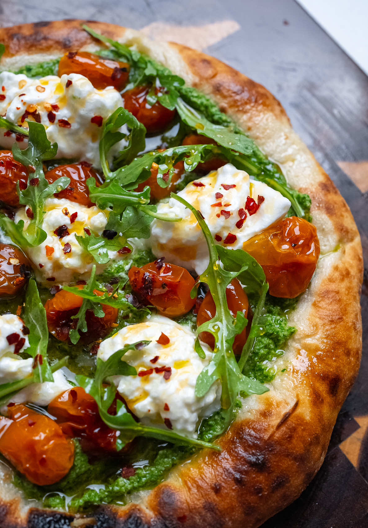 Burrata Caprese Pizza Whether it’s for the Super Bowl or Valentine’s Day, this Neapolitan-style Caprese pizza is a solid choice. Topped with fresh basil pesto, creamy burrata, and slow-roasted cherry tomato confit, then finished with a drizzle of hot honey for that perfect balance of flavors. I used a homemade Neapolitan-style dough in a pizza oven, but any pizza or focaccia will work. #superbowlfood #nycfoodie #hothoneypizza #neapolitanpizza #ValentinesDay #laeats #burrata  Super Bowl party food Burrata pizza recipe Game day eats Valentine’s Day dinner idea