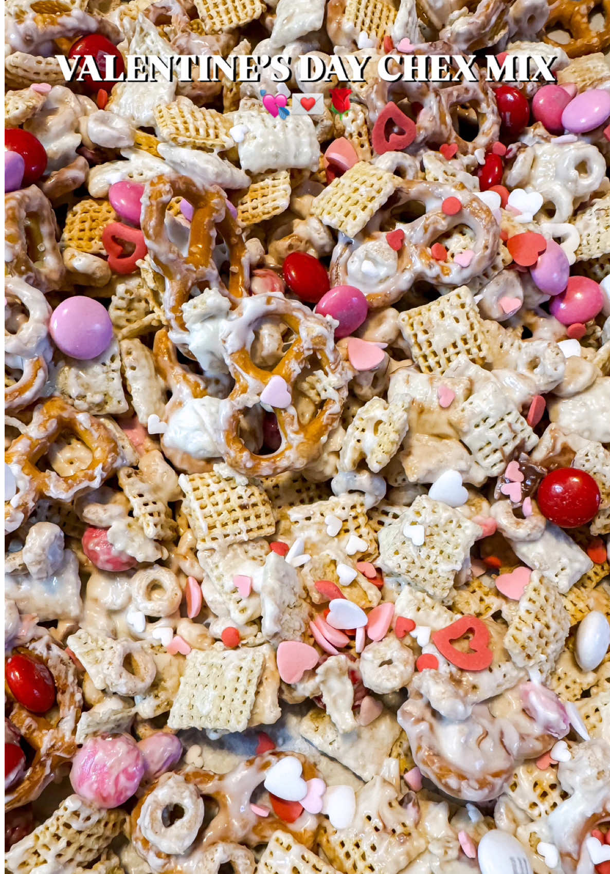 If you’ve been looking for a quick and tasty Valentine’s Day treat, look no further — this Valentine’s Day Chex Mix is a crowd pleaser!! You’ll need: 2 cups Rice Chex  2 cups Corn Chex  1 1/2 cups Cheerios 1 1/2 cups pretzels (regular or gluten free) 1 cup Valentine’s Day M&M’s 16 oz. white chocolate chips or chocolate candy melts Mix the cereal, pretzels, and 1/2 cup of M&M’s together. Melt the chocolate in the microwave in 20-30 second increments, stir, and pop back in the microwave until it’s fully melted. Pour the melted chocolate over the cereal mixture and stir until everything is fully coated. Transfer the mixture to a baking sheet covered with parchment paper and sprinkle with the other 1/2 cup of M&Ms and Valentine’s Day sprinkles. That’s it!! Enjoy 🥰❤️ #ValentinesDay #valentinesdiy #valentinesdayideas #valentinesdaybaking #bakingrecipe #bakingszn #chexmix #EasyRecipe #EasyRecipes 