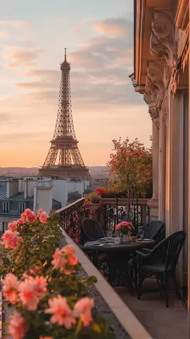 A balcony in full bloom with the Eiffel Tower in the distance—Paris never ceases to enchant. #fyp #ParisVibes #BalconyView #EiffelTower #MorningMagic 