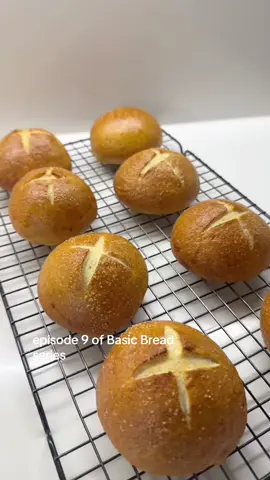 Basic Breads Ep 10 - Pretzel Rolls 🥨  Dough: 260g Lukewarm Water  7g Instant Yeast  1 x tbs sugar  400g Bread Flour  1 x tsp salt  Oil for greasing Salt for sprinkling  1/2 egg white (I save the rest of the egg)  1 x tsp Honey & Bicarbonate of Soda for boiling  Mix water & yeast, add sugar and mix again. Add salt and flour and mix well until combined. Use your hand to combine then using a dough scraper or spatula fold the dough over itself 10 to 20 times on each side. (If you’re comfortable with kneading you can knead it for 5min)  Grease a clean bowl all over with some oil and the top of your cling film and place the dough in the clean bowl for 1 -1.5 hours to rise. Once risen punch down your dough, take out and roughly shape into a circle and cut into 8 (no flour on surface it will be oily instead) shape each piece into a ball and place on little squares of parchment paper. Cover and rest for 30 min. Heat oven to 220C. Boil water in a large pan, get egg white ready, a tea towel and a skated spoon. Add parchment paper to 2 trays. Once rolls are ready turn water to simmer add honey and soda and simmer for 45 seconds on each side, be gentle when flipping them over and taking them out you don’t want to dent them. Rest your spoon on the tea towel before adding to dish to get rid of excess water, brush with egg wash quickly, sprinkle with salt, cut them if you’re doing so and get them in the oven while they’re warm. Bake 4 on each tray and swap the trays over half way through. When the second lot are boiled just add them to the oven (you can bake both trays at the same time) bake for 20-22 min Enjoy D 🫶  #bread #pretzel #fyp 