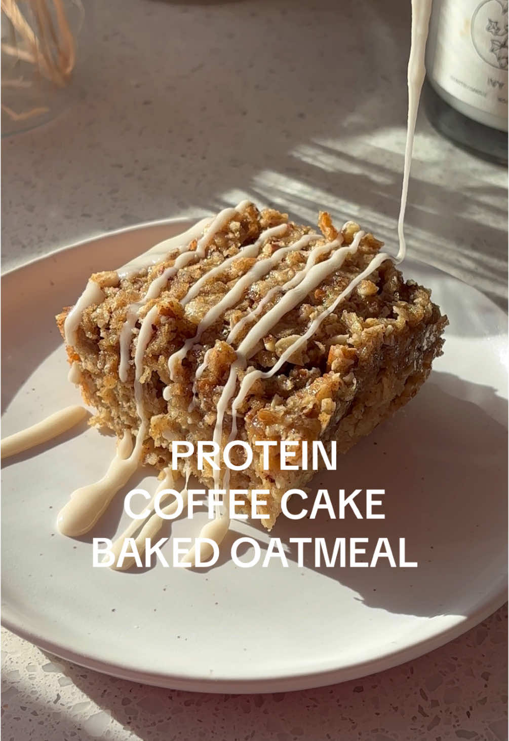 Episode 3 of my Meal Prep Protein Baked Oatmeal Series - Coffee Cake Baked Oatmeal ☕️ I cannot get over these. CANNOT. End of story 🤤🤤 INGREDIENTS - COFFEE CAKE OATMEAL 2 cups gluten-free rolled oats (1 cup blended into flour) 1 tsp baking powder 1/2 tsp salt 1 tsp ground cinnamon 1/4 tsp ground nutmeg 2 scoops vanilla protein powder (I used @pescience Gourmet Vanilla) 2 mashed bananas 1/4 cup maple syrup 2 tsp vanilla extract 2 eggs 1 cup unsweetened almond milk WALNUT TOPPING 1/4 cup gluten-free rolled oats 1/2 cup nuts of choice (I used walnuts) 1 tbsp gluten-free all purpose flour 1/2 tsp ground cinnamon 1/3 monk fruit brown sugar 1/4 cup melted coconut oil VANILLA GLAZE (optional) 1/2 cup powdered sugar 1 tbsp whole milk or unsweetened almond milk 1/2 tsp vanilla extract DIRECTIONS - 1) Set your oven to 350°F (175°C) and grease a 8x8 inch baking dish with coconut oil or cooking spray. Then add half of your gluten-free rolled oats to a high speed blender and process into a fine flour. 2) In a large bowl, combine oats, oat flour, baking powder, salt, cinnamon, nutmeg, and vanilla protein powder. 3) In a separate bowl, mash the bananas until smooth, then whisk in the maple syrup, vanilla extract, eggs, and almond milk. Pour into the dry ingredients and stir until combined. 3) Add oats, walnuts, flour, cinnamon brown sugar, brown sugar and melted coconut oil to a food processor. Pulse a few times until a crumbly, textured streusel forms. Should resemble wet sand. 4) Pour the oatmeal mixture into the prepared baking dish and evenly sprinkle the blended walnut oat streusel over the top. Bake for 30-35 minutes, or until the top is golden brown and the oatmeal is set. 5) Let it cool slightly before slicing. Serve warm with a drizzle of maple syrup, Greek yogurt, coconut butter or a drizzle of vanilla icing! #bakedoatmeal #easybreakfast #breakfastrecipe #easybreakfastrecipe #coffeecake #coffeecakeoats #deliciousbreakfast #mealprepbreakfast 