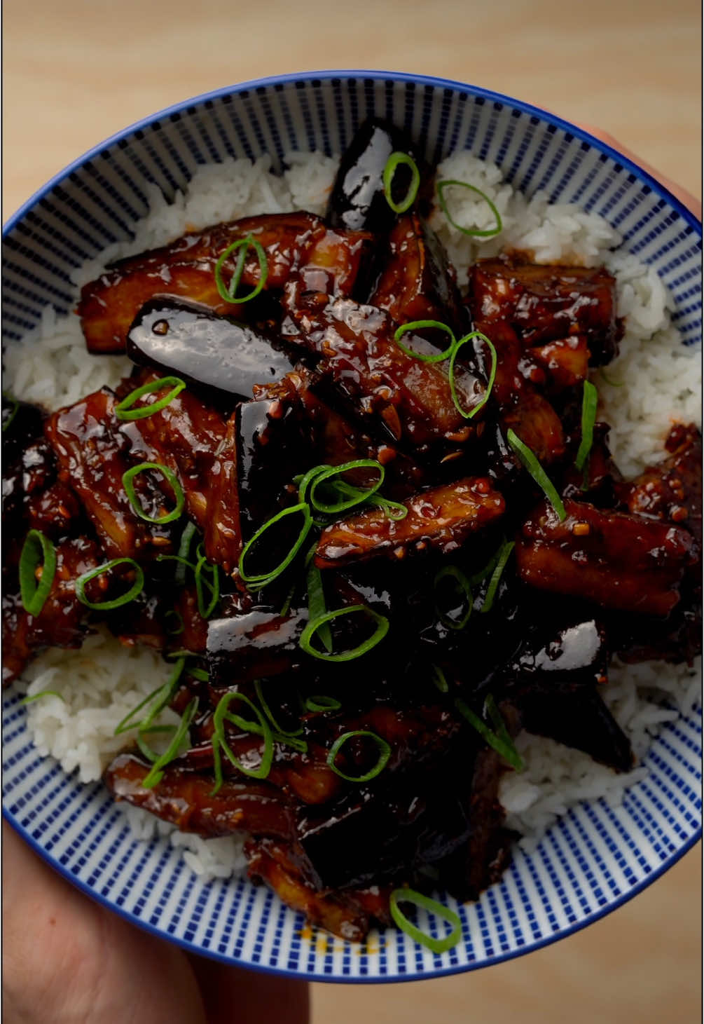Sichuan-Style Eggplant (Yu Xiang Qie Zi) Ingredients For the Eggplant: 2 large eggplants (about 500 g) 1 tsp salt 2 tbsp potato starch 3 tbsp oil (e.g., peanut or vegetable oil) For the Sauce: 2 tbsp Doubanjiang (Chinese chili bean paste) 2 tsp dark soy sauce 1 tbsp light soy sauce 1 tbsp black rice vinegar (or balsamic/apple cider vinegar) 1 tbsp sugar 1/2 tsp msg 2 tsp Shaoxing rice wine (or dry sherry) 50 ml water For the Aromatics: 3 garlic cloves, finely chopped 1 piece of ginger (about 2 cm), finely chopped 2 spring onions, white and green parts separated 1 tsp Sichuan peppercorns 1 tsp sesame oil Instructions: 1. Prepare the Eggplant Cut the eggplants into 5 cm-long strips. Sprinkle with salt and let sit for 15 minutes to draw out excess moisture. Pat dry with a paper towel. Lightly coat with starch to improve texture when frying. 2. Fry the Eggplant Heat oil in a large pan or wok over medium heat. Fry the eggplant until golden brown on all sides (about 5–7 minutes). Remove and set on paper towels to drain excess oil. 3. Sauté the Aromatics In the same pan, heat a little more oil. Toast the Sichuan peppercorns until fragrant. Add the white parts of the spring onions, garlic, and ginger, and stir-fry briefly. 4. Make the Sauce Stir in the Doubanjiang and fry until the oil turns slightly red. Add the soy sauces, vinegar, sugar, msg, rice wine, and water. 5. Combine Everything Return the fried eggplant to the pan and mix well with the sauce. 6. Finish and Serve Garnish with the green parts of the spring onions and drizzle with sesame oil. Serve hot with steamed jasmine or fragrant rice. hashtags: #EasyRecipes #EasyRecipe #Recipe #cooking #food #sichuan #sichuaneggplant #eggplant #aubergine #sichuanaubergine #sichuanstyleeggplant #sichuanstyleaubergine #chinesefood #vegan #veganrecipes #vegetarian #vegetarianfood #eggplantrecipe #auberginerecipe
