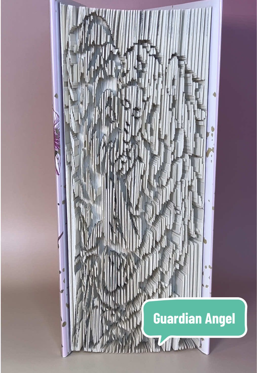 This Book Art piece took me about 30 hours and I made it as a gift for a domestic violence victim to remind her how strong she is. #bookart #bookfoldingart #bookfolding #domesticviolenceawareness #guardianangel 