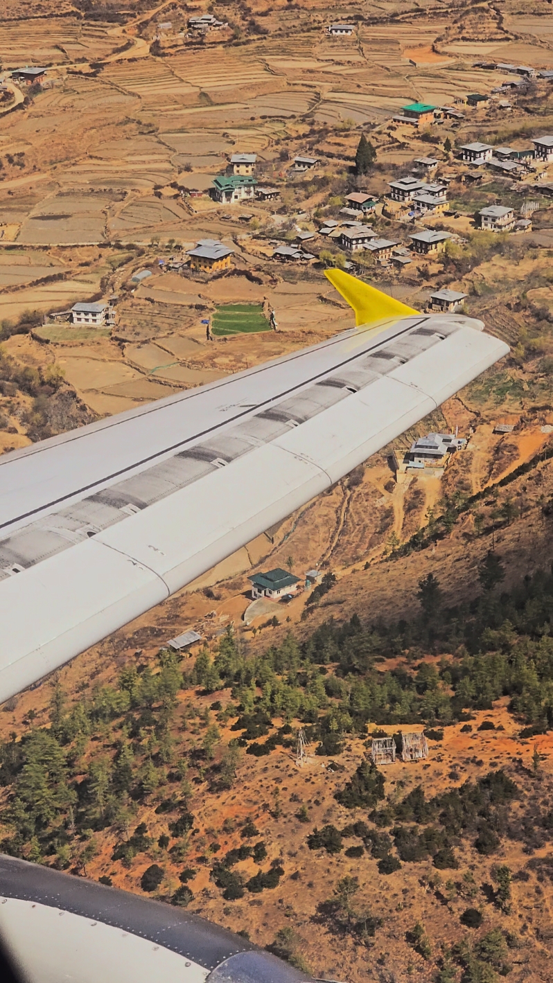 A Scenic Ascent: Soaring Through Bhutan's Majestic Landscapes on a Bhutan Airlines Flight from Paro! Embark on a breathtaking journey as your Bhutan Airlines flight takes off from Paro Airport, one of the world's most challenging and scenic airports. From the holding point on the southerly facing runway, the iconic Paro Dzong stands proudly in view, framed by lush green mountains and the serene valley. During the takeoff roll, the aircraft glides close to rugged mountain slopes and traditional Bhutanese homes perched on the hillsides, offering a thrilling start to your adventure. As the aircraft lifts into the sky, you’re treated to a stunning aerial view of terraced fields and clusters of traditional villages nestled in the valley. The powerful hum of the CFM engines echoes through the mountains as the plane climbs gracefully, revealing ancient monasteries like Dakarpo and Dongkola, their golden roofs glinting in the sunlight.  While the confluence of the Thimphu and Paro Rivers may not be directly visible, the aircraft's right turn makes it evident that you’re flying over this natural marvel, with the capital city of Thimphu cradled in its own picturesque valley in the distance. As you continue to climb, the snow-capped peaks of Dagala come into view, their pristine slopes glistening with fresh snow from recent western disturbances. Light turbulence adds a touch of adventure, reminding you of the untamed beauty of the Himalayas. This flight is more than just a journey—it’s a visual and sensory feast, showcasing the breathtaking landscapes and cultural richness of Bhutan. Sit back, relax, and let the wonders of the Land of the Thunder Dragon unfold before your eyes.   #bhutan  #paroairport  #himalayas  #travelgoals  #bucketlist  #bhutanairlines  #scenicflight  #drukair 