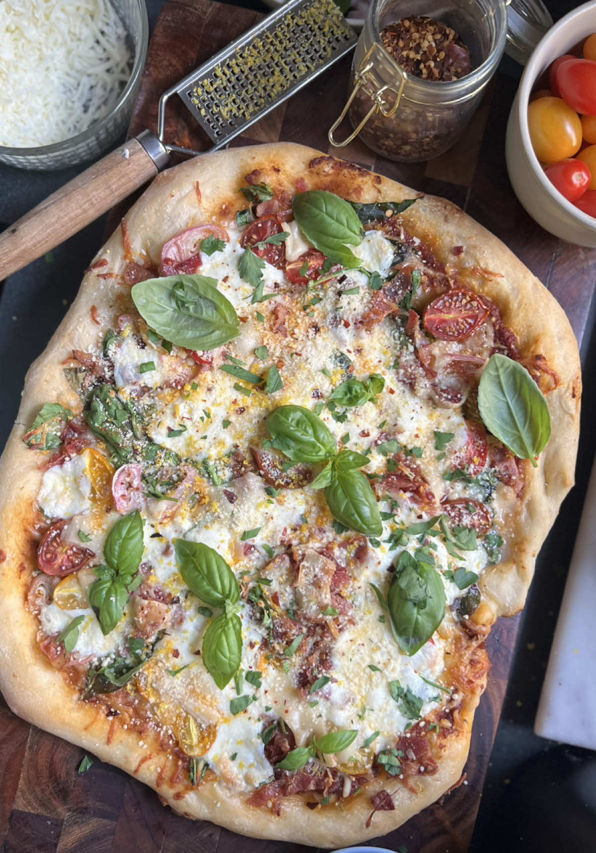 Thanks for the memes and mems!! You all had such a profound impact on my life, If a Pizza were a love letter, I’d write this to you. and you will be missed..(again)  CREAMY SUNDRIED TOMATO AND LEMON PIZZA  Love Hayden & Max  Ingredients:  Prep: 10 minutes Total:45 minutes  1lb Pizza dough 6oz sundried tomato paste (or try some red pesto! Or puree your own) 8oz Mozzarella cheese, divided  1c Spinach, roughly chopped 1 Shallot (even better if you fry them) you could probably sub this w/ roasted garlic ½lb optional Protein (id recommend pepperoni, sausage, bacon)  A handful of Cherry tomatoes, roughly chopped  1 ball Burrata Shaved Parm - However much you put on your Olive Garden salad 1 Lemon juice and zest, reserve zest for garnish   Optional Red pepper flakes  Optional 1-2oz fresh parsley, basil, or oregano, roughly chopped  Set oven to 350 degrees Begin my rolling out your dough onto a lightly floured surface (about a 1 tbsp) into the size you would like your pizza, use the remaining dust on  the bottom before putting it on the baking sheet. Add the tomato paste to the crust, followed by some of the mozzarella cheese, spinach, shallots, protein if using, tomato, then the remaining mozzarella, crack open the burrata and spread it out, add some parm, lemon juice and red pepper flakes.  Bake for 35-40 minutes until it gets nice and browned and bubbly! Garnish with some shaky parm, lemon zest, fresh herbs, cut serve and enjoy! Thanks for being here! #marrymepizza #delishaas #thanksforthememes 